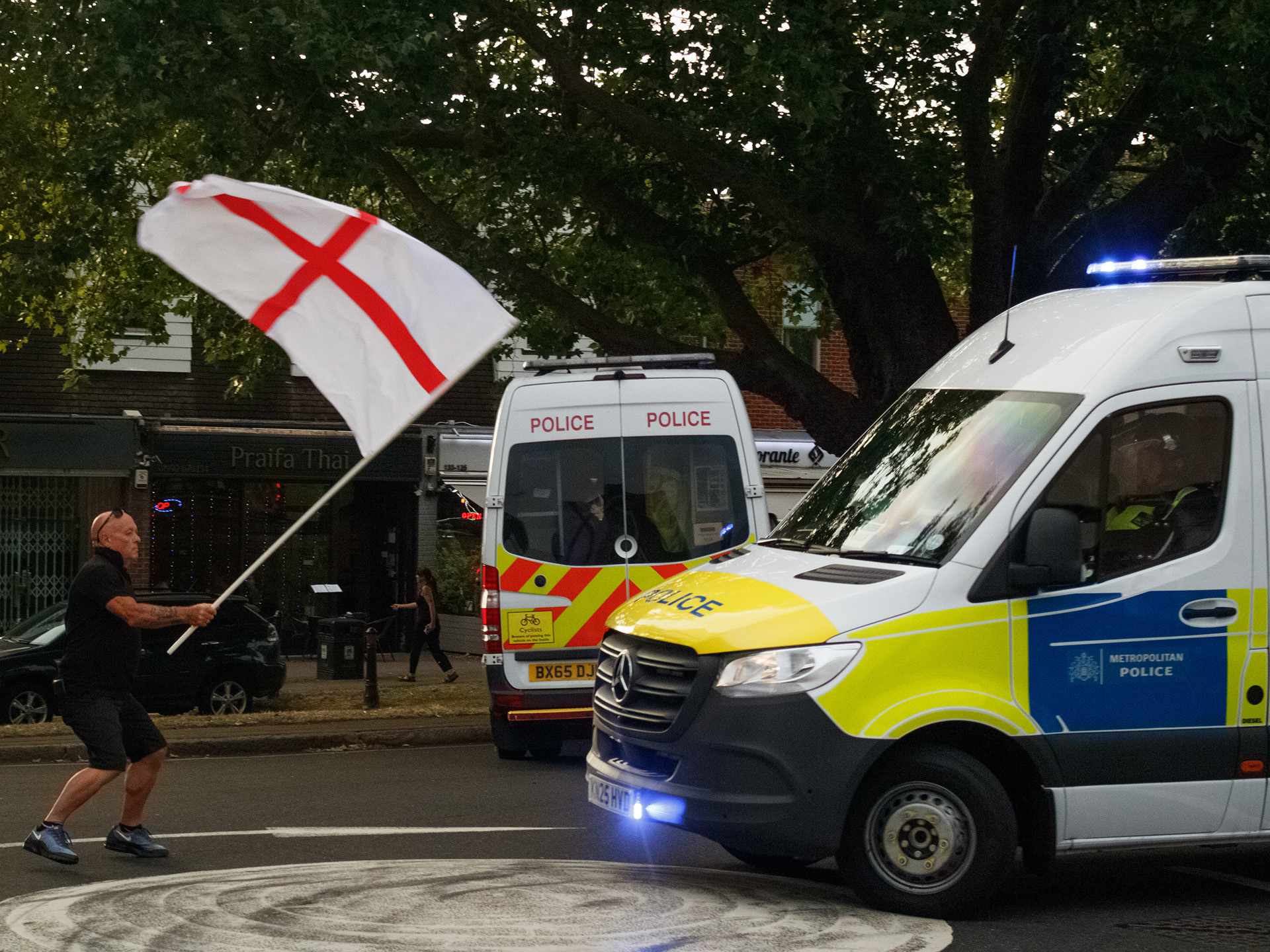 July 17th, 2025 - A protester with an English flag in front of a police van