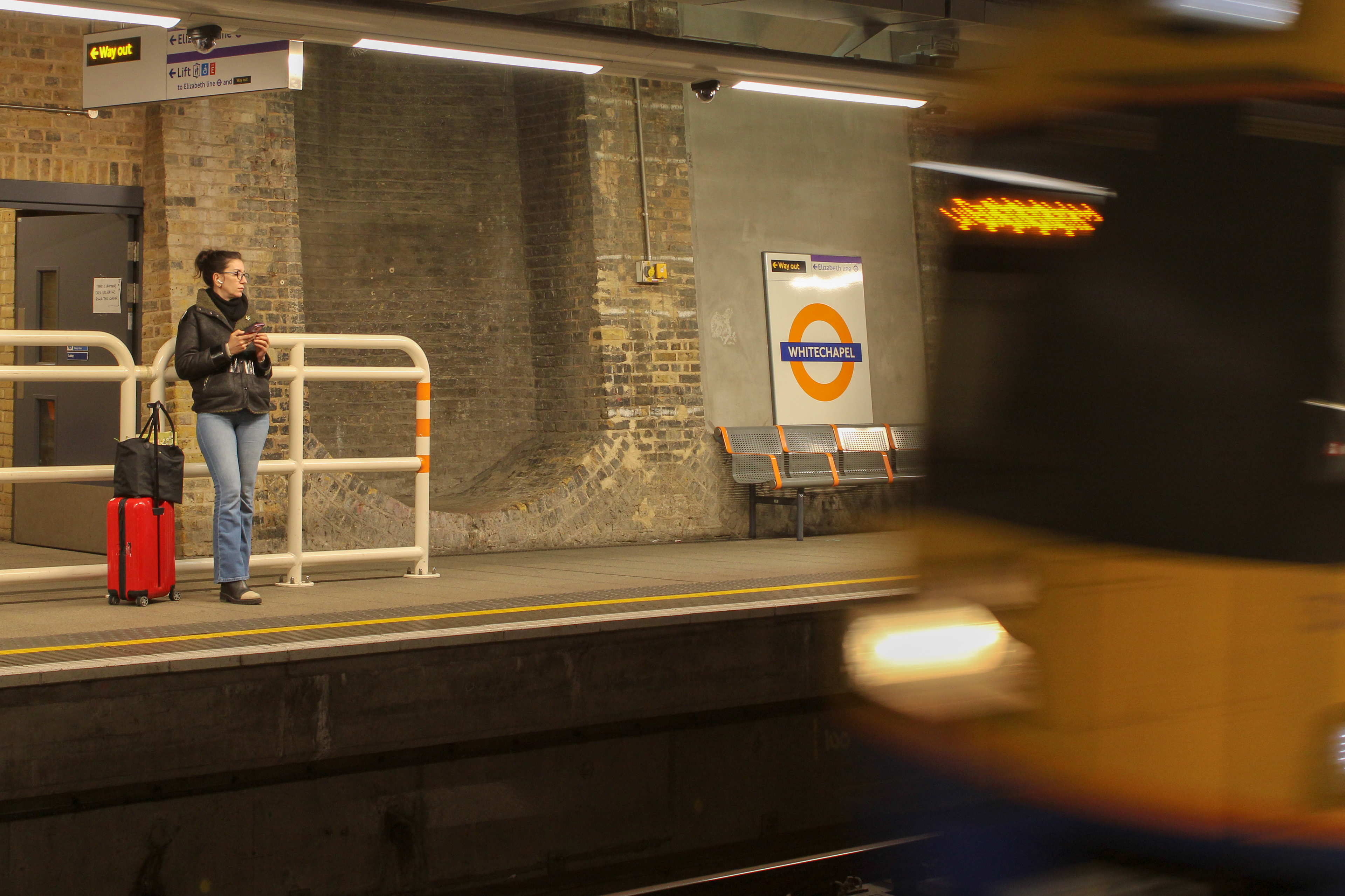 April 18th, 2025 - A person waits for a London Overground train