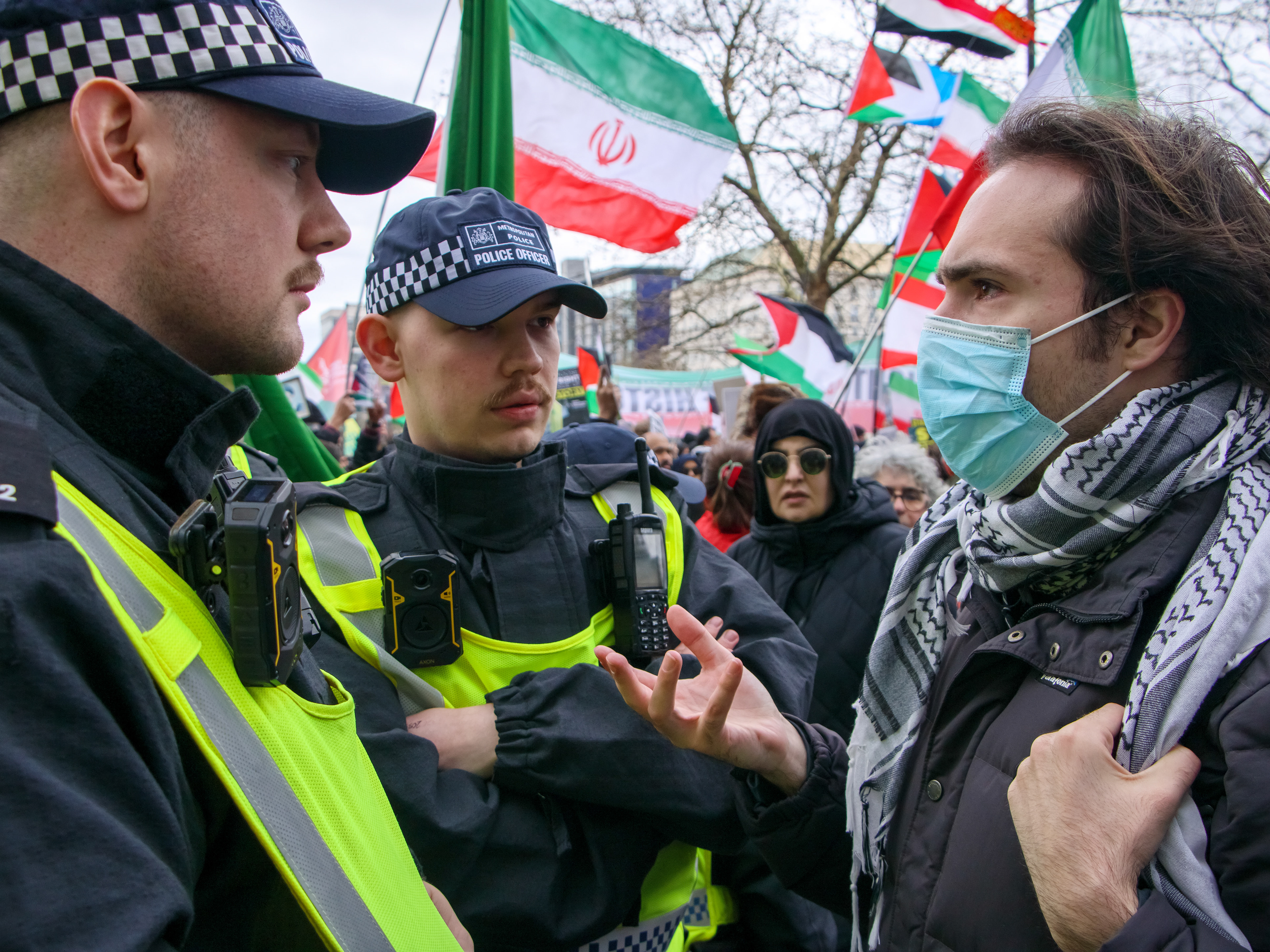 March 15th, 2026 - Police instruct a protester to remove his face covering