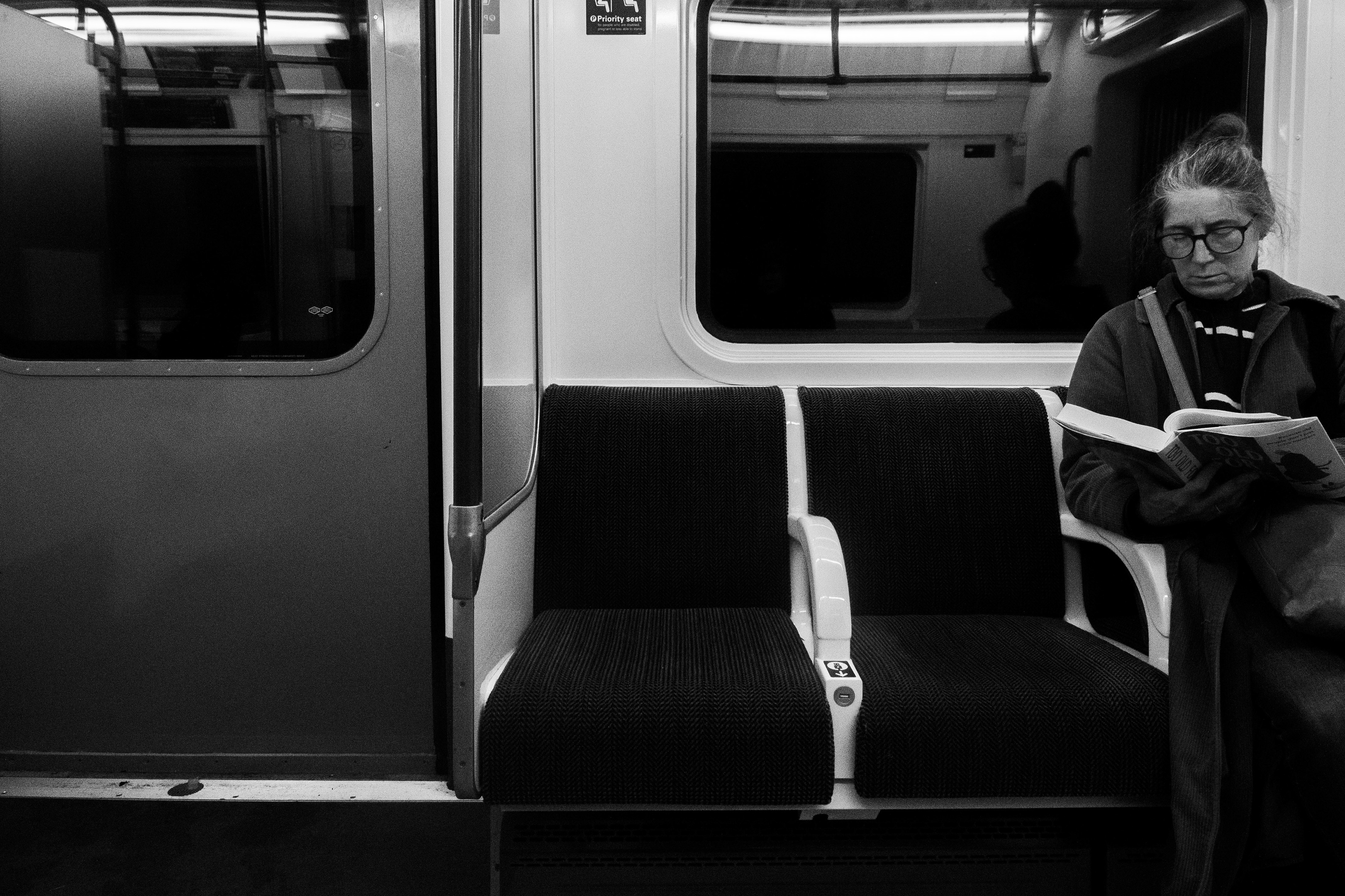 Feb 7, 2026 - A train passenger reads a newspaper