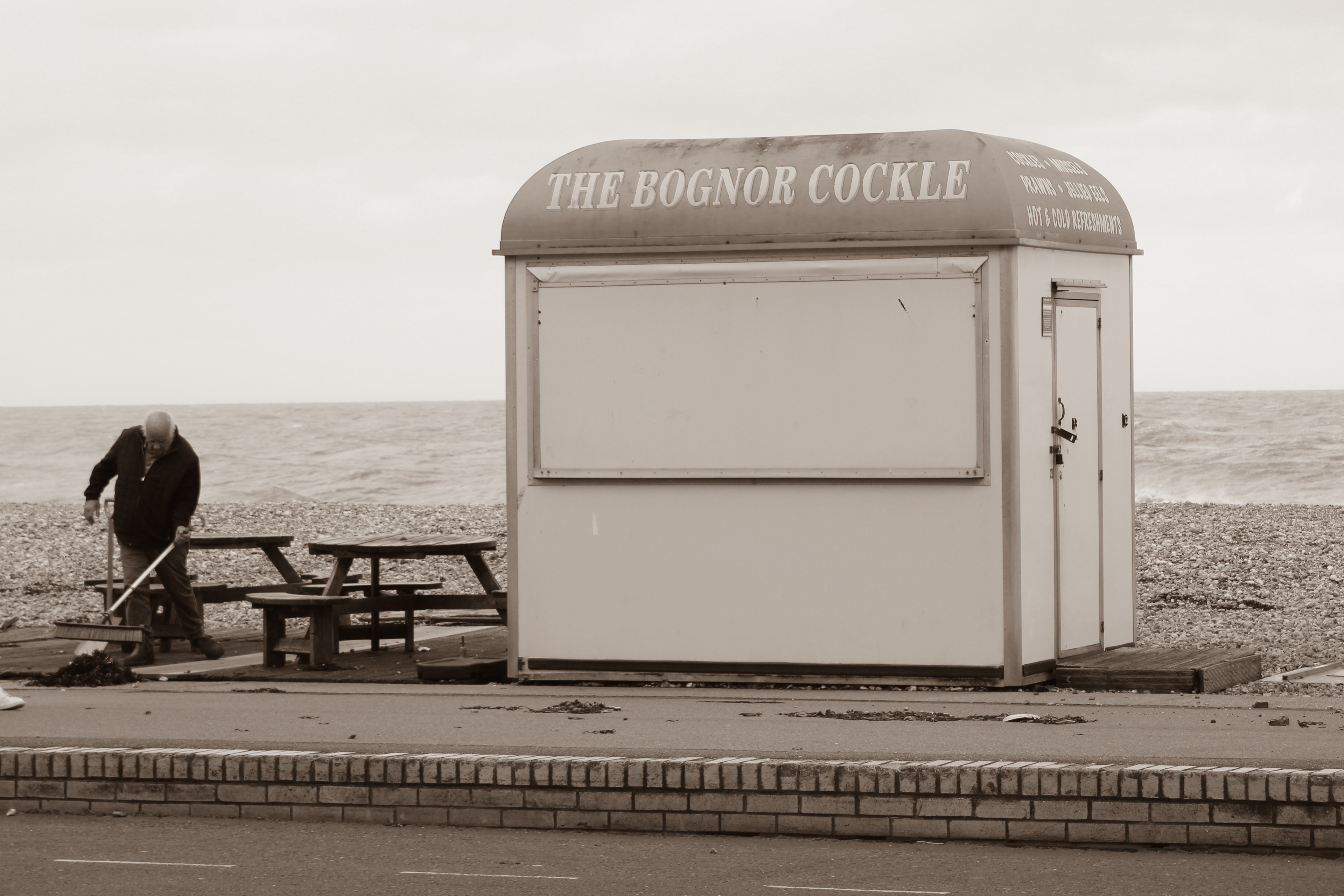 April 9th, 2024 - A man sweeps around a hut on the coast