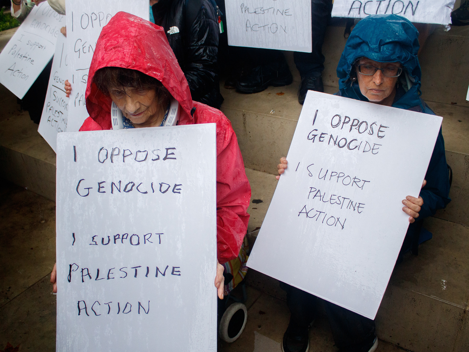 July 19th, 2025 - Placards being held by protesters that reads "I oppose genocide, I support Palestine Action" which breaches section 3 of the terrorism act 2000