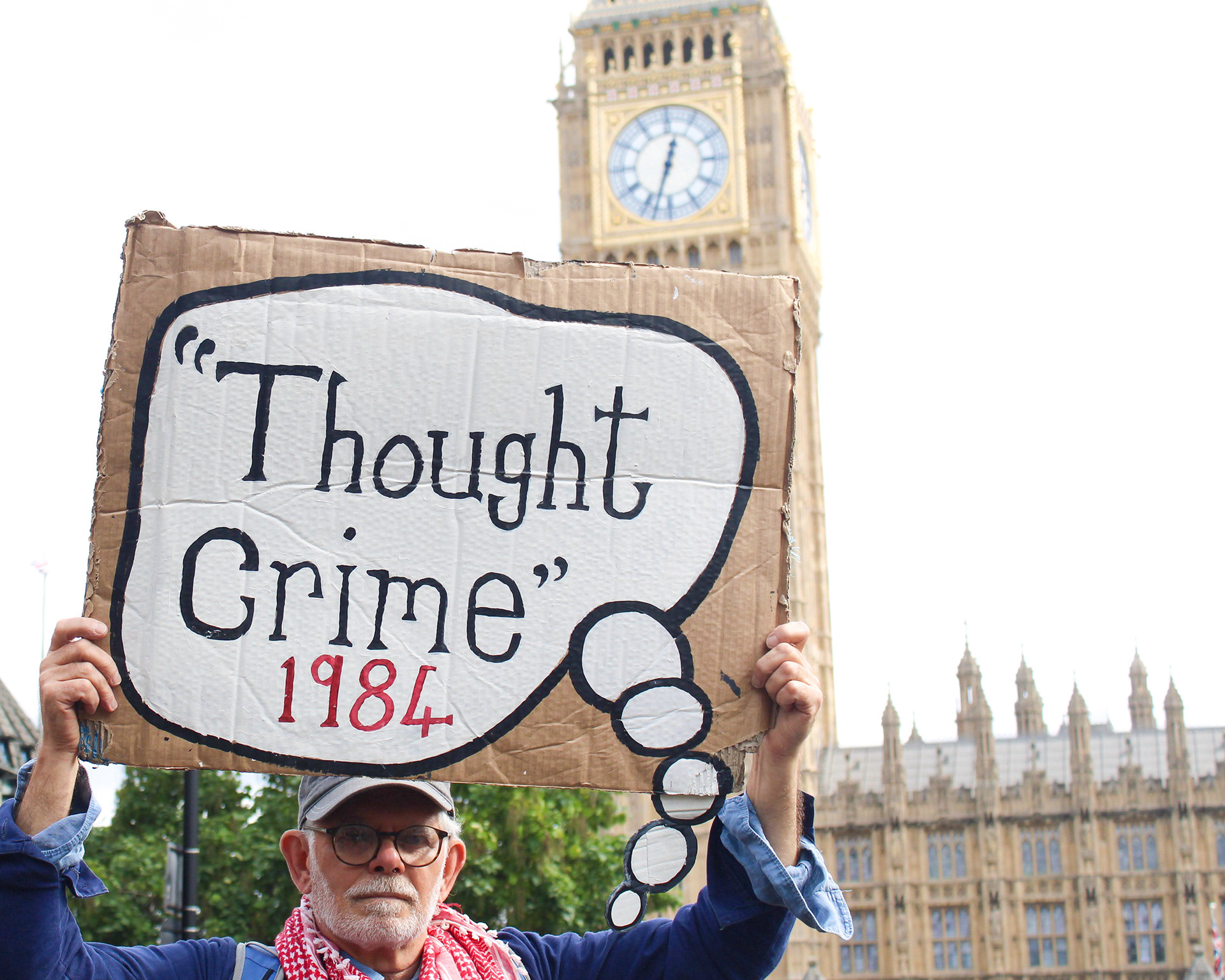 September 6th, 2025 - A protester holds a placard that reads "Thought Crime 1984" outside of UK Parliament