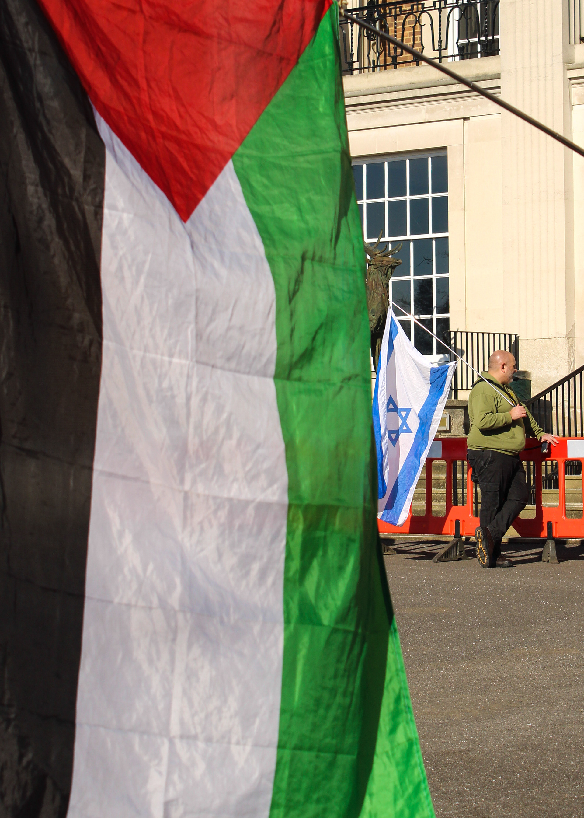March 3rd, 2025 - A Palestine flag is seen next to a pro Isreal protester in London