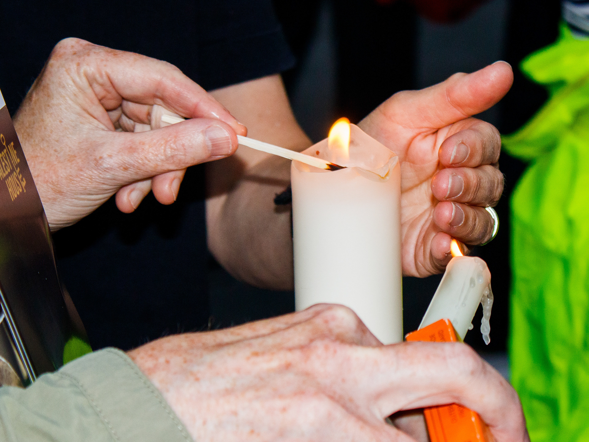 August 13th, 2025 - Protesters hold a candle at a vigil