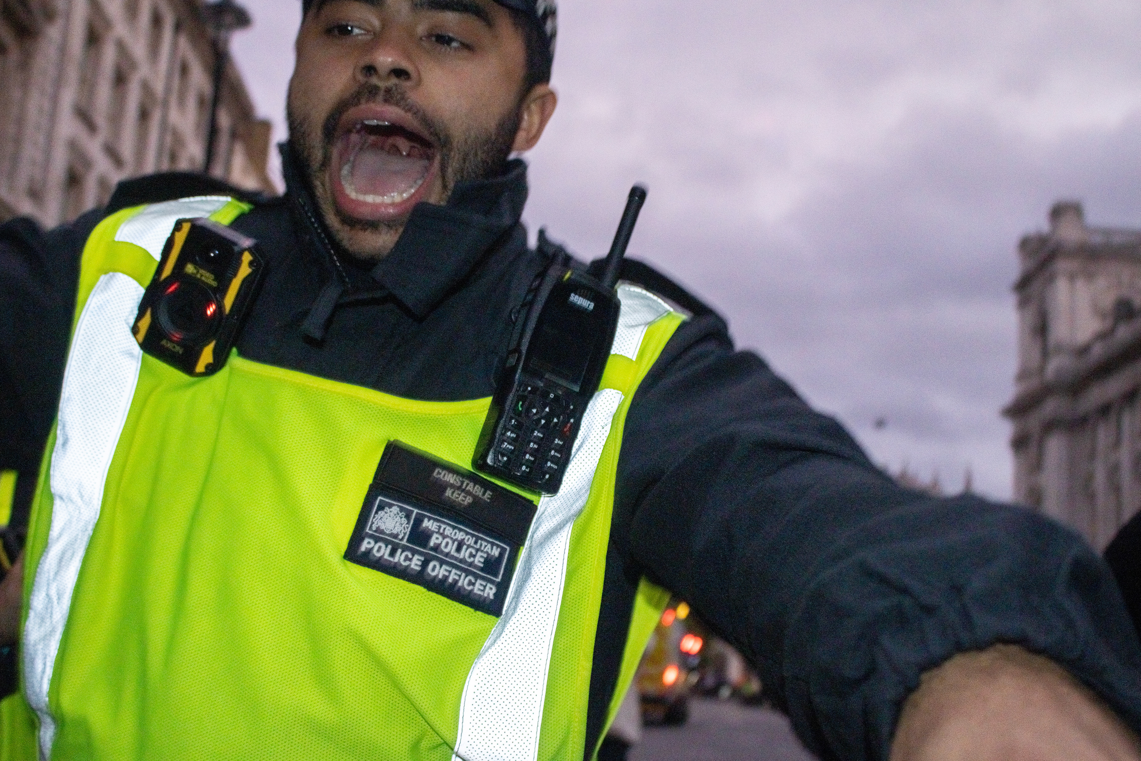 October 4th, 2025 - A police officer shoves protesters (and press)