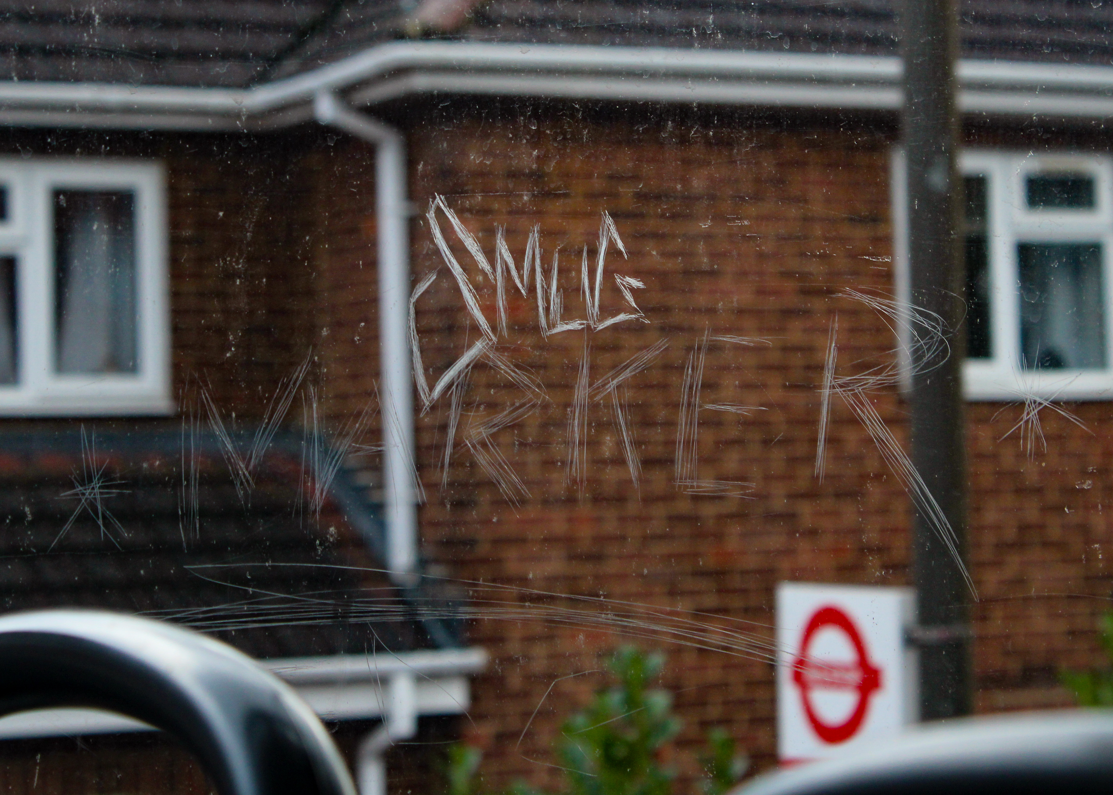 February 18th, 2024 - Graffiti sketched into a window of a bus 