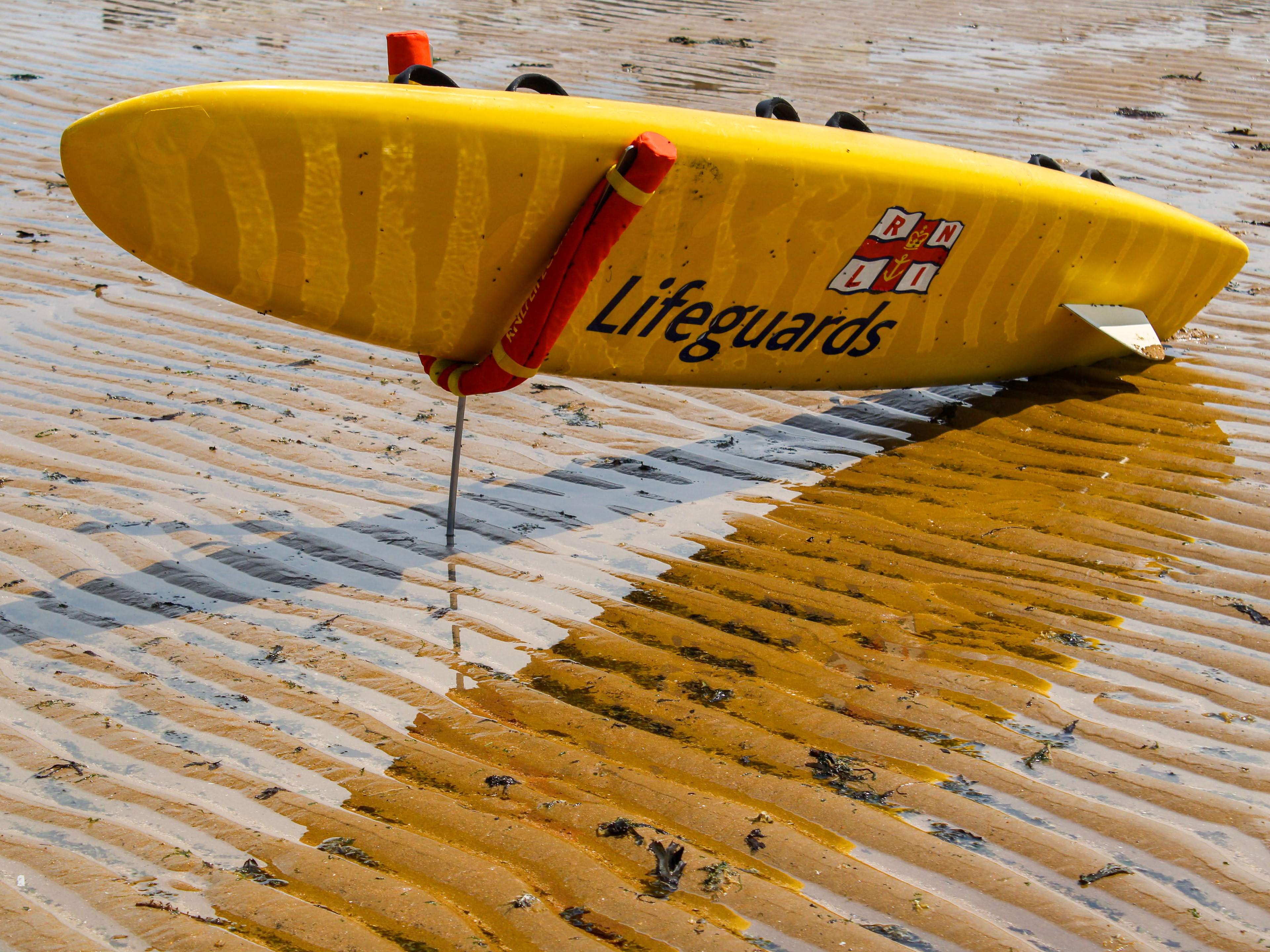 July 23rd, 2025 - RNLI surfboard on a beach