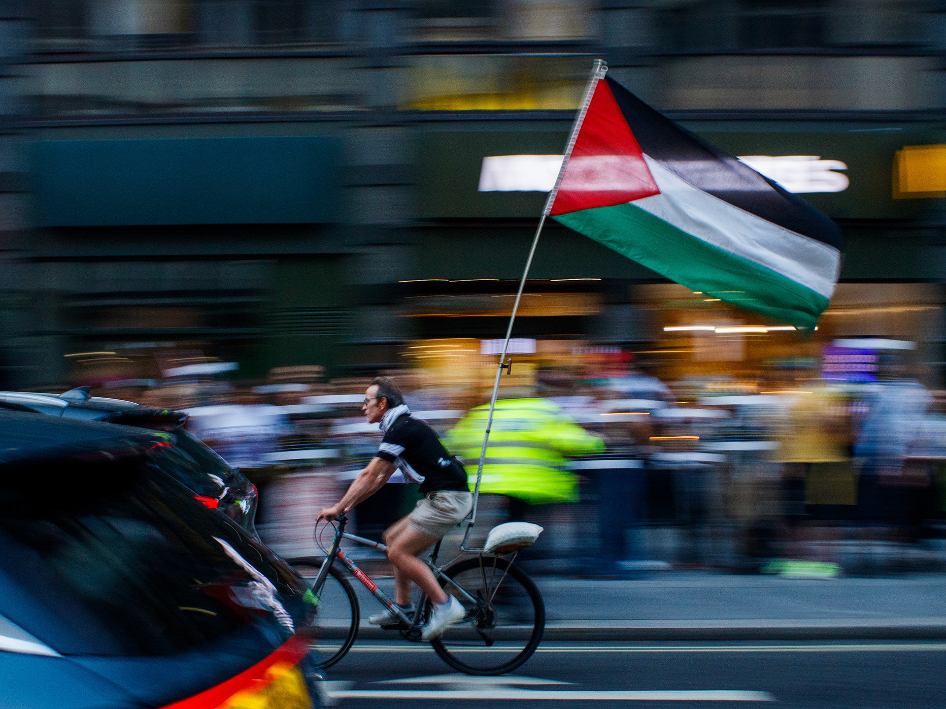 August 13th, 2025 - A cyclist with a Palestinian flag on his bike 