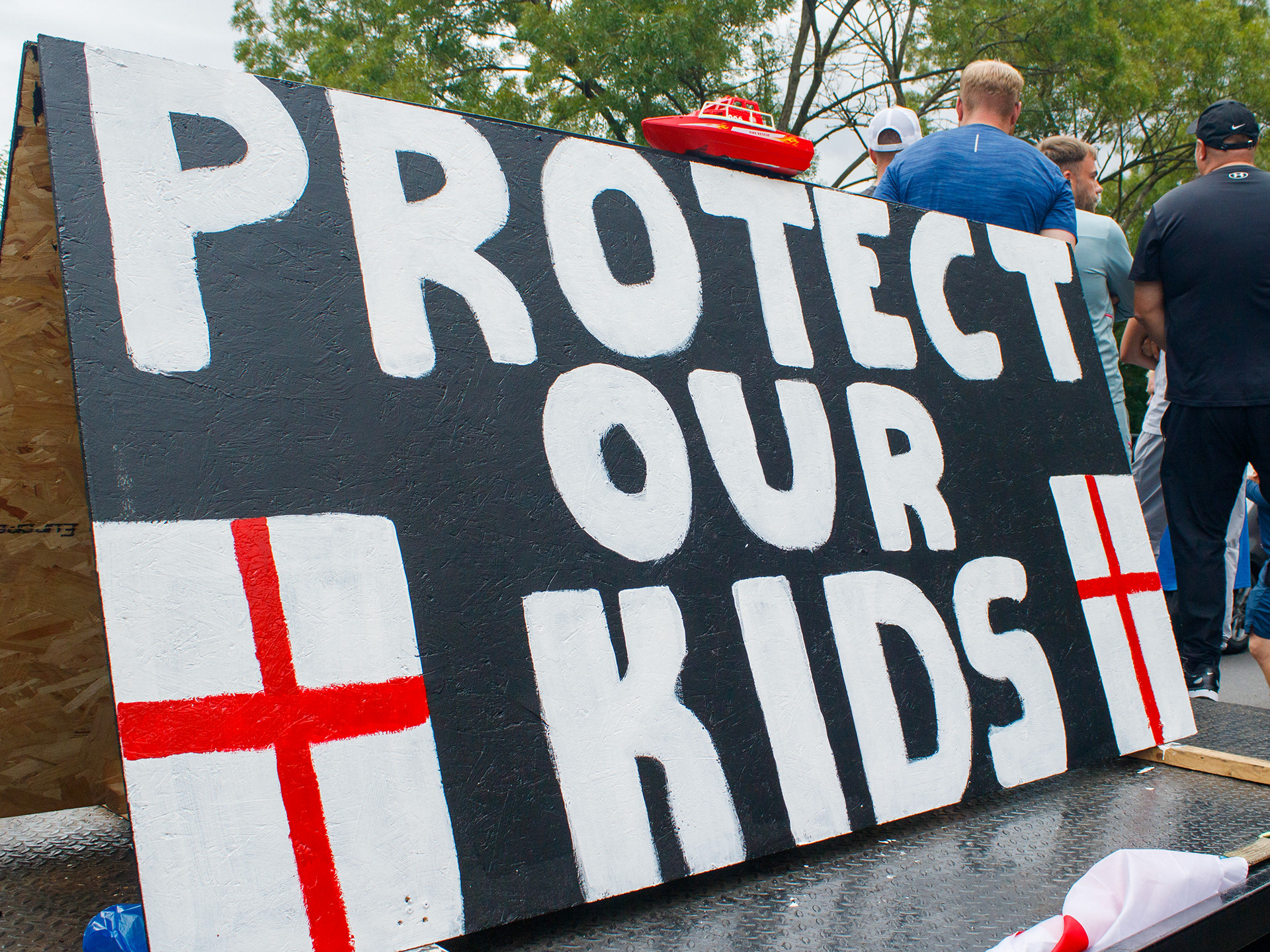 July 17th, 2025 - A sign with "protect our kids" written on it 