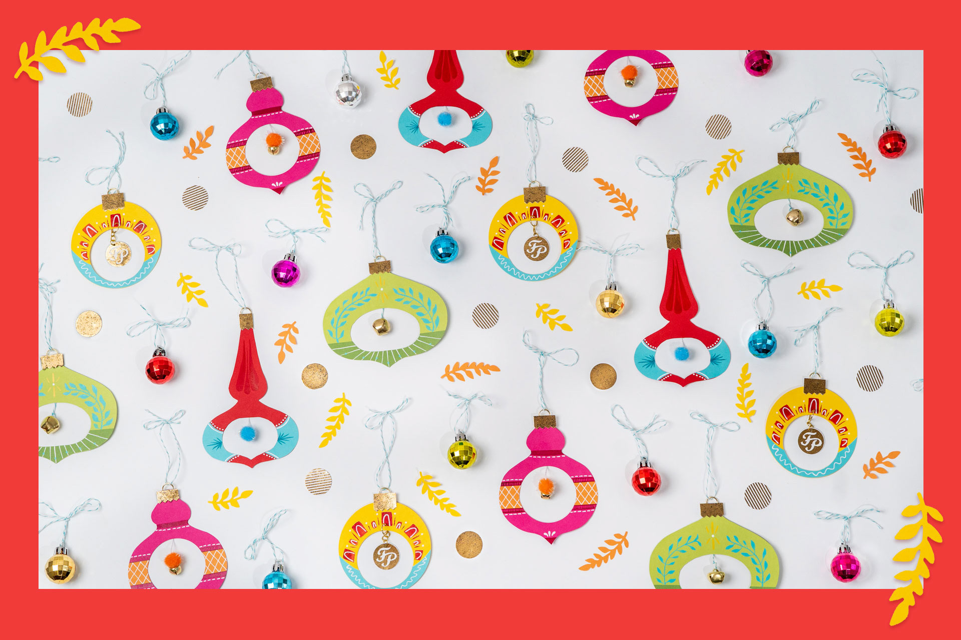 Image of colorful vintage paper ornaments spread out on a white background.