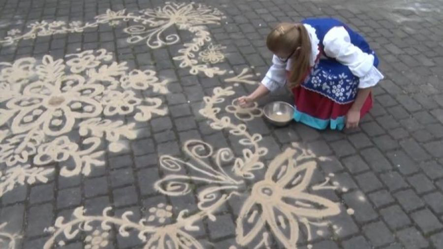 "Sypanie piaskiem," or the pouring of sand, is a part of the intangible cultural heritage of rural Central Poland. Patterns drawn on the ground in houses, thresholds, pathways, and courtyards brought protection and luck to families and community. The practice almost became extinct during the past 100 years, but is experiencing a recent resurgence as people seek to revive this cultural practice