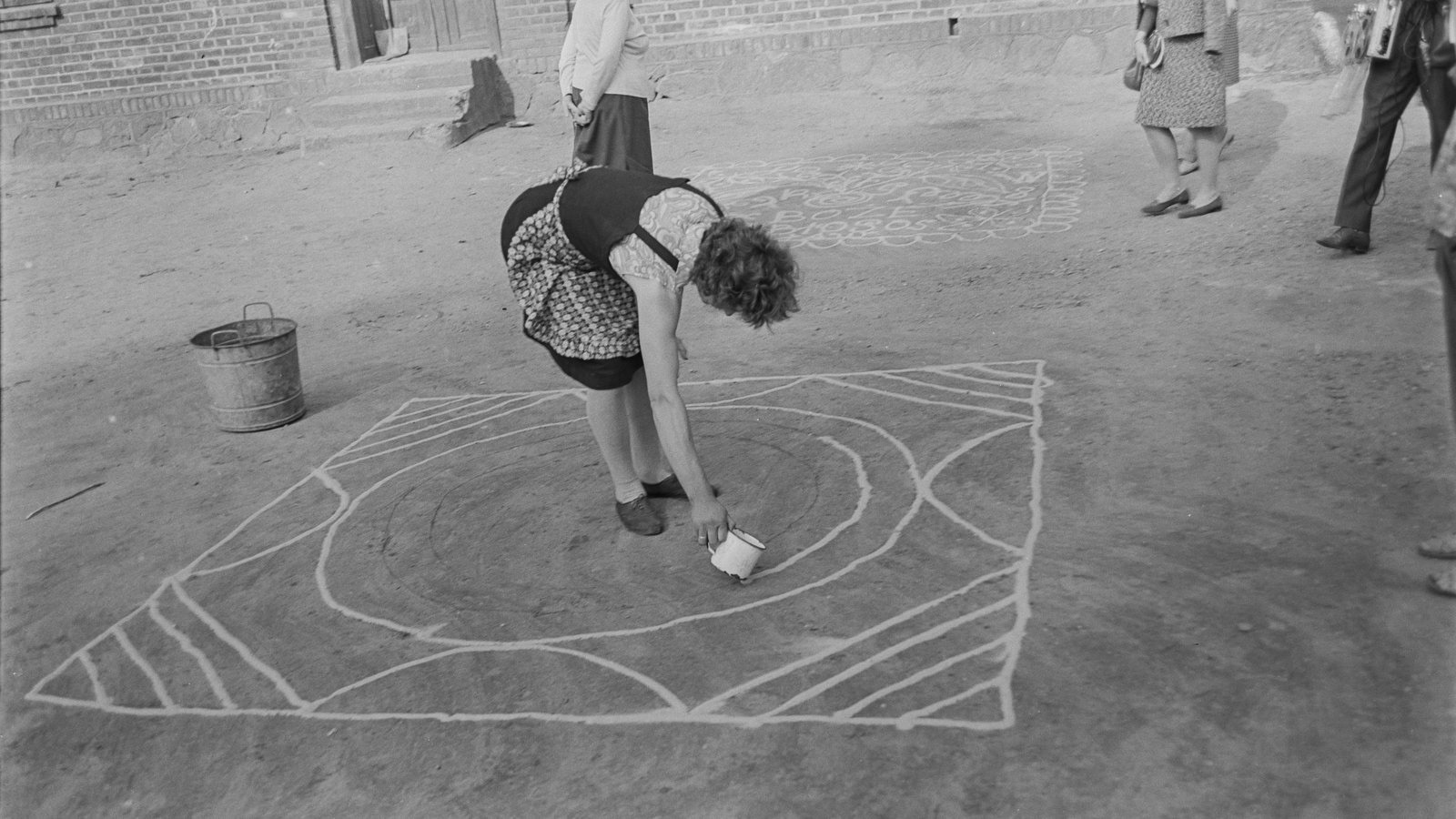 "Sypanie piaskiem," or the pouring of sand, is a part of the intangible cultural heritage of rural Central Poland. Patterns drawn on the ground in houses, thresholds, pathways, and courtyards brought protection and luck to families and community. The practice almost became extinct during the past 100 years, but is experiencing a recent resurgence as people seek to revive this cultural practice
