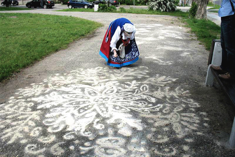 "Sypanie piaskiem," or the pouring of sand, is a part of the intangible cultural heritage of rural Central Poland. Patterns drawn on the ground in houses, thresholds, pathways, and courtyards brought protection and luck to families and community. The practice almost became extinct during the past 100 years, but is experiencing a recent resurgence as people seek to revive this cultural practice