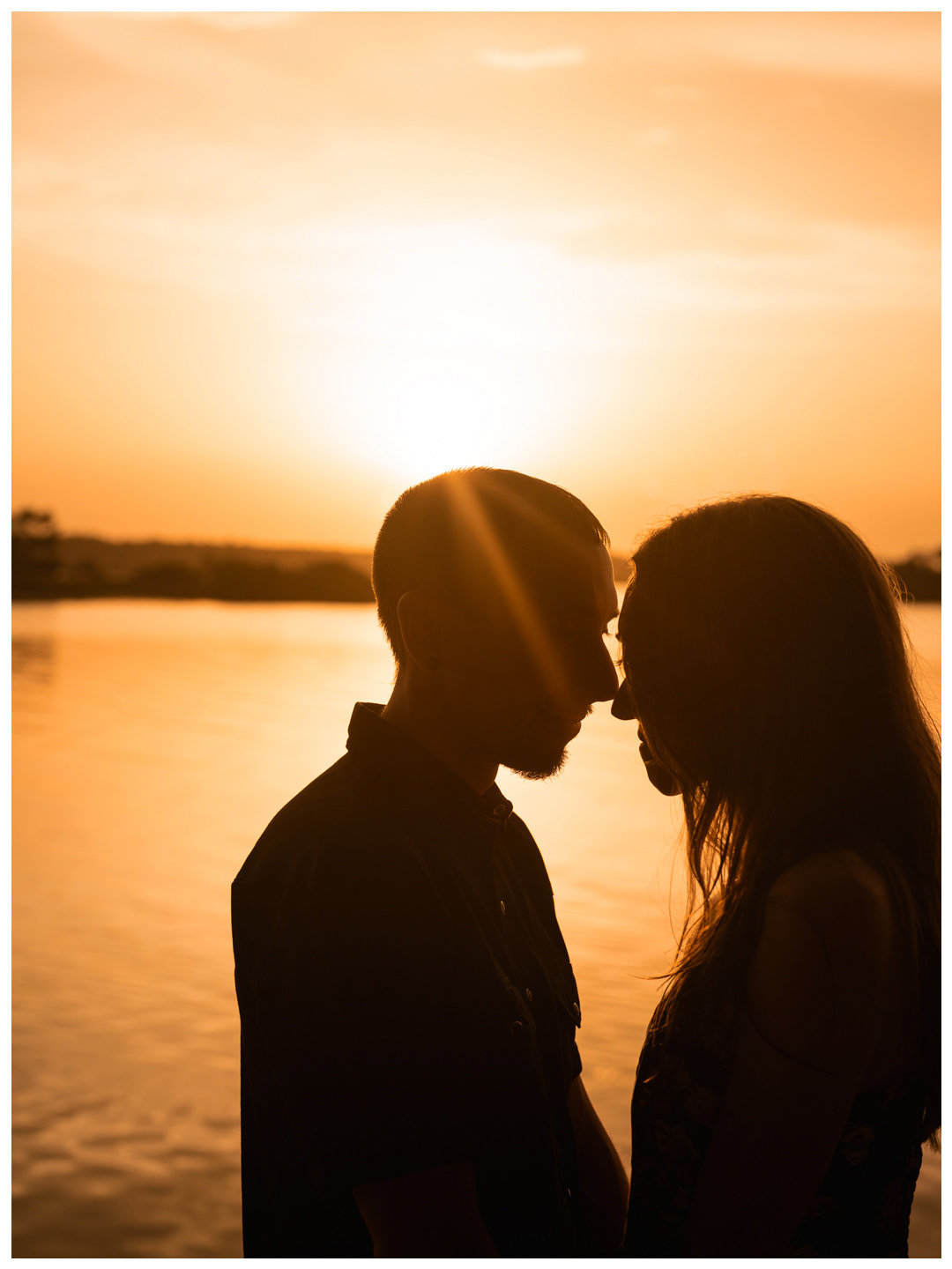 Close silhouette of a couple facing one another with sunlight between them at Washington Oaks.