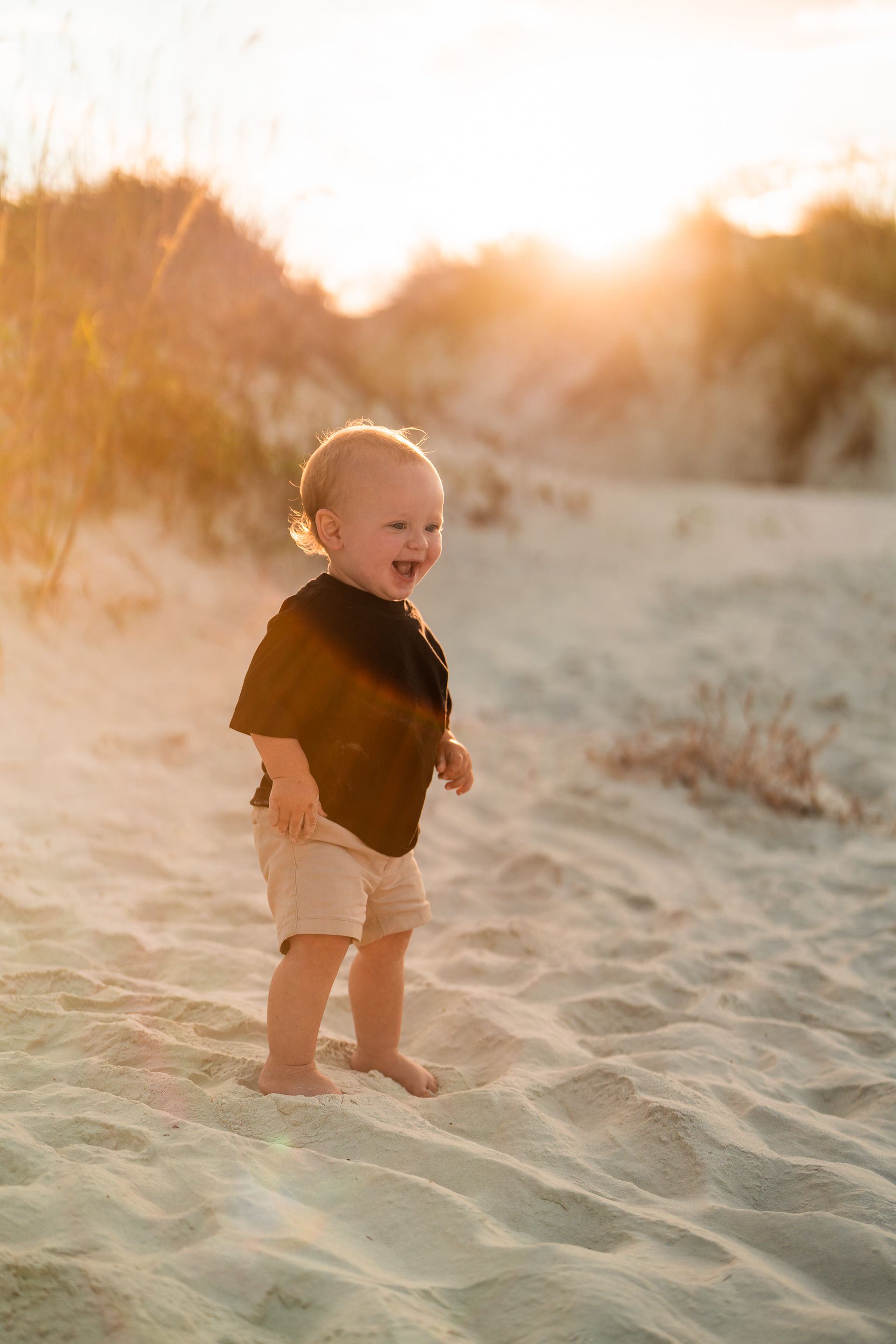 Toddler walking in the sand at sunset during a Ponce Inlet family photography session.