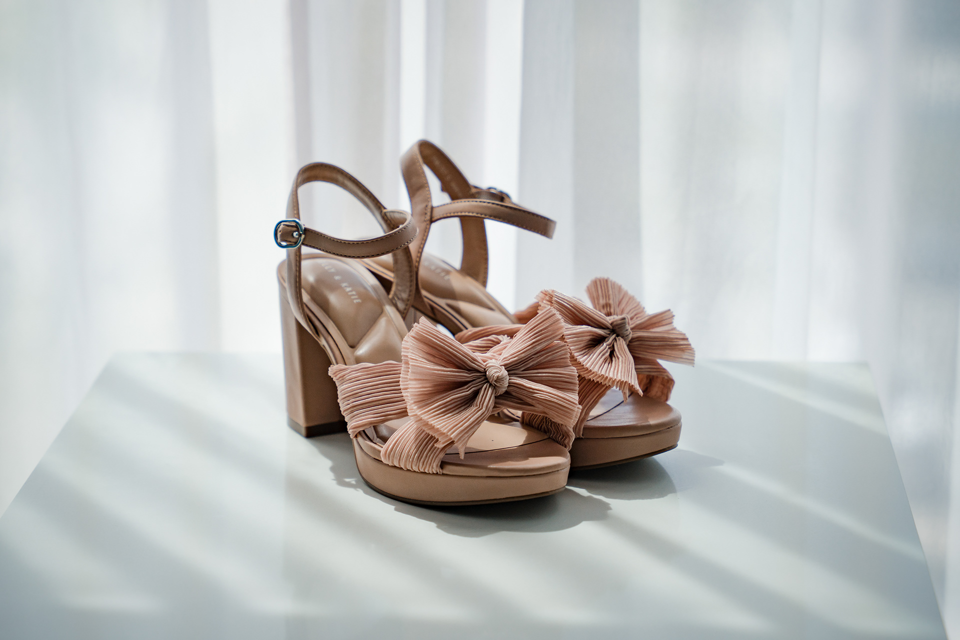 Bridal heels by the window before a wedding at Hard Rock Hotel Daytona Beach.