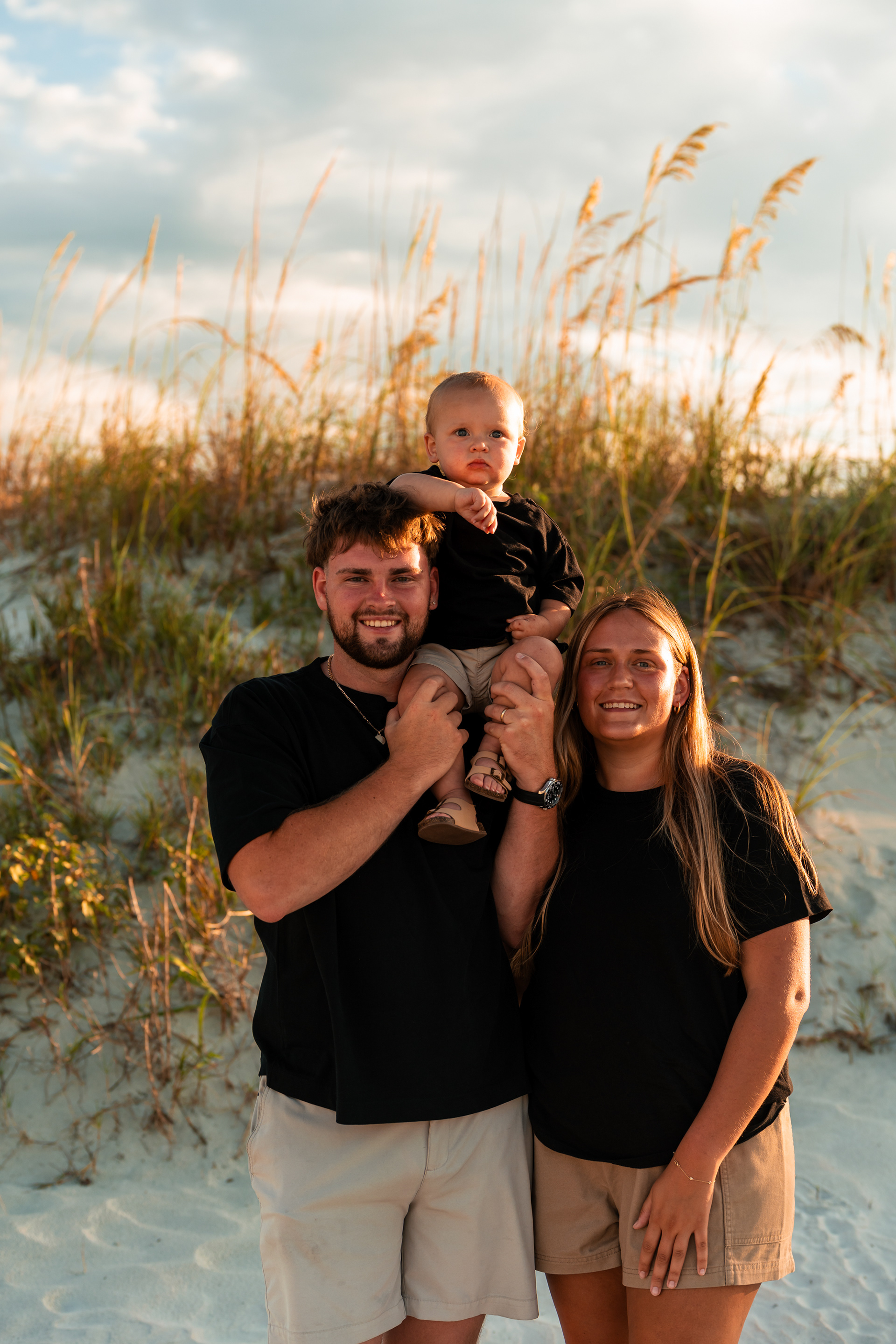 Parents smiling with their child during a Ponce Inlet Beach family photography session.