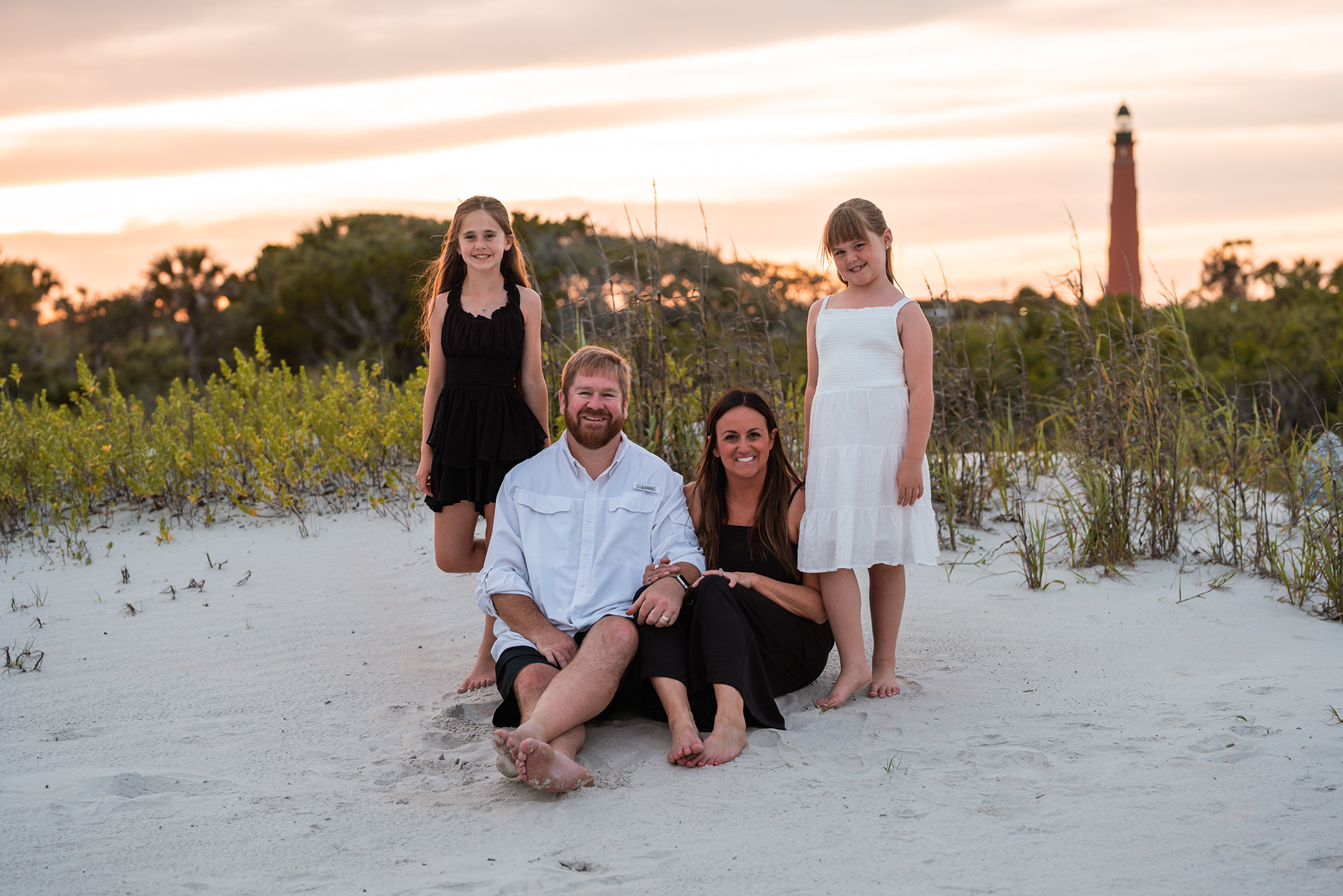 Family portrait in the dunes with the Ponce Inlet Lighthouse in the background.