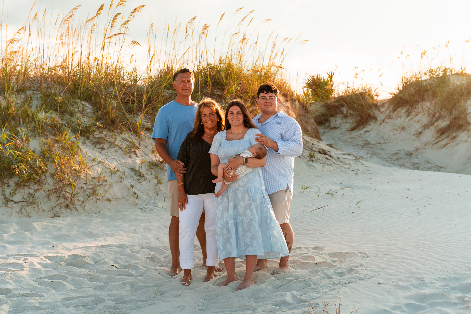 Family portrait in the dunes during a beach photography session at Ponce Inlet Jetty Beach.
