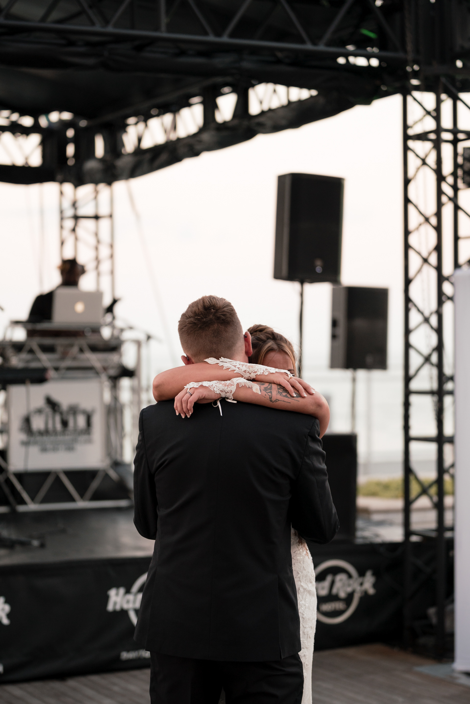 Black and white candid hug during a Daytona Beach wedding reception.