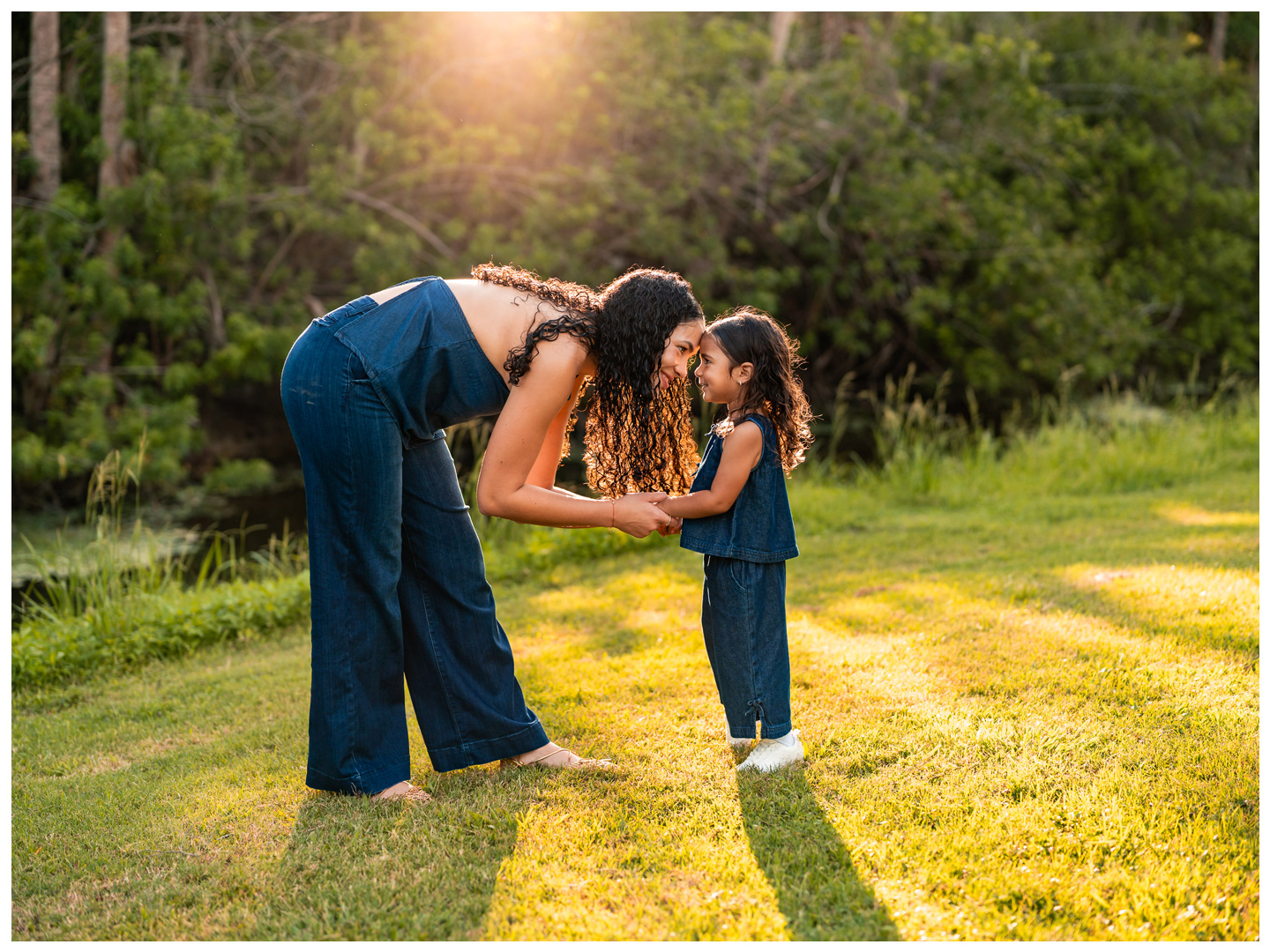 Mother and daughter sharing a sweet moment in golden light at Buschman Park