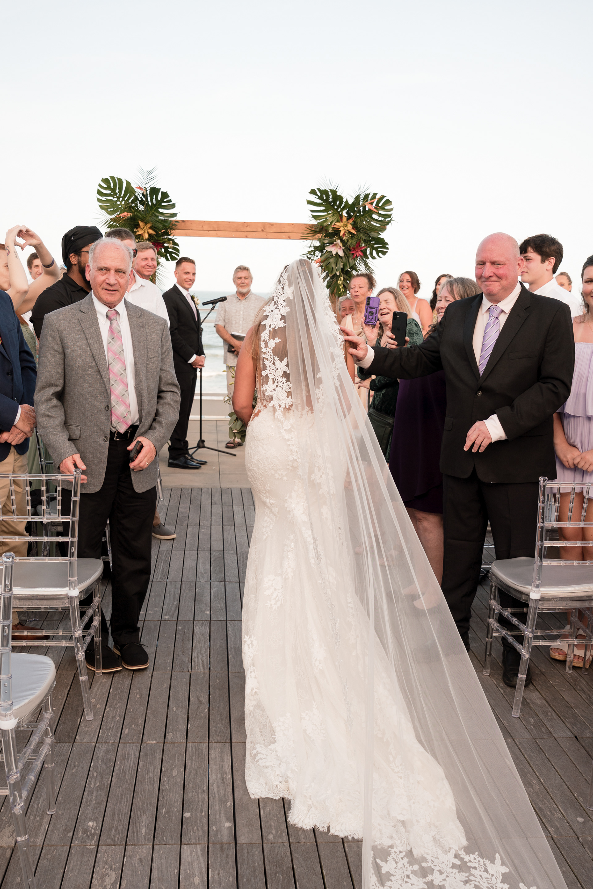 Bride walking down the aisle during an oceanfront wedding in Daytona Beach.