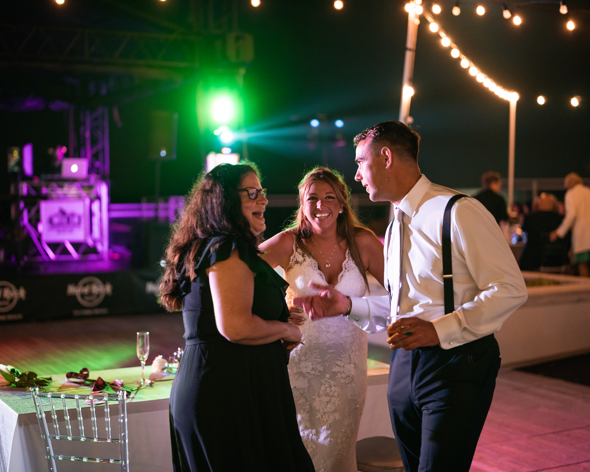Bride and groom laughing with guests during their Hard Rock Hotel Daytona Beach wedding reception.