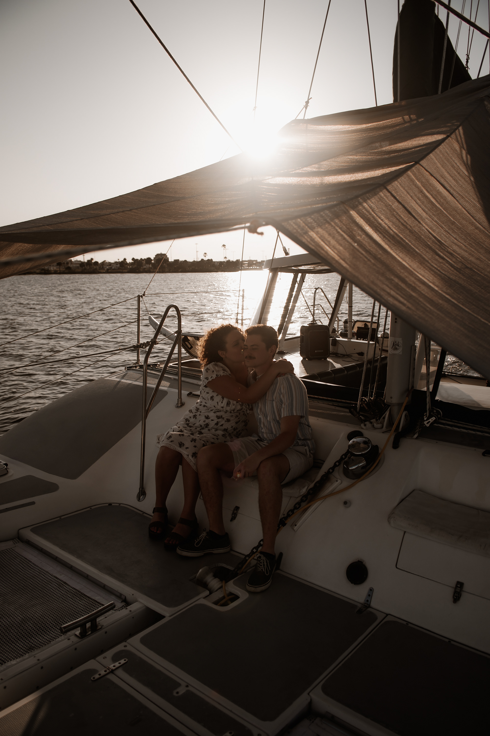 sailboat engagement photo of couple sitting together on a boat in Daytona Beach