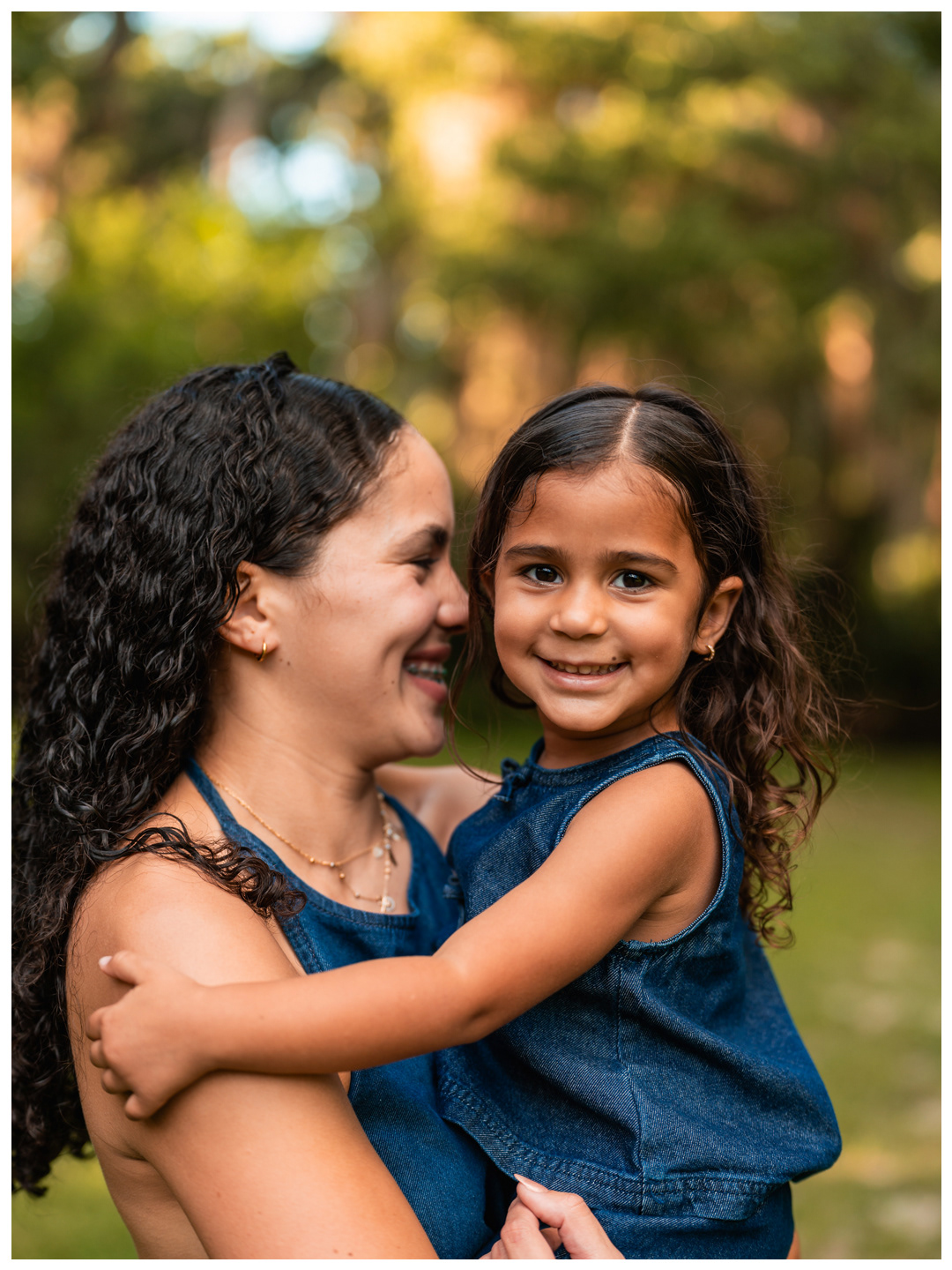 Candid mother and daughter photo with daughter smiling at Buschman Park