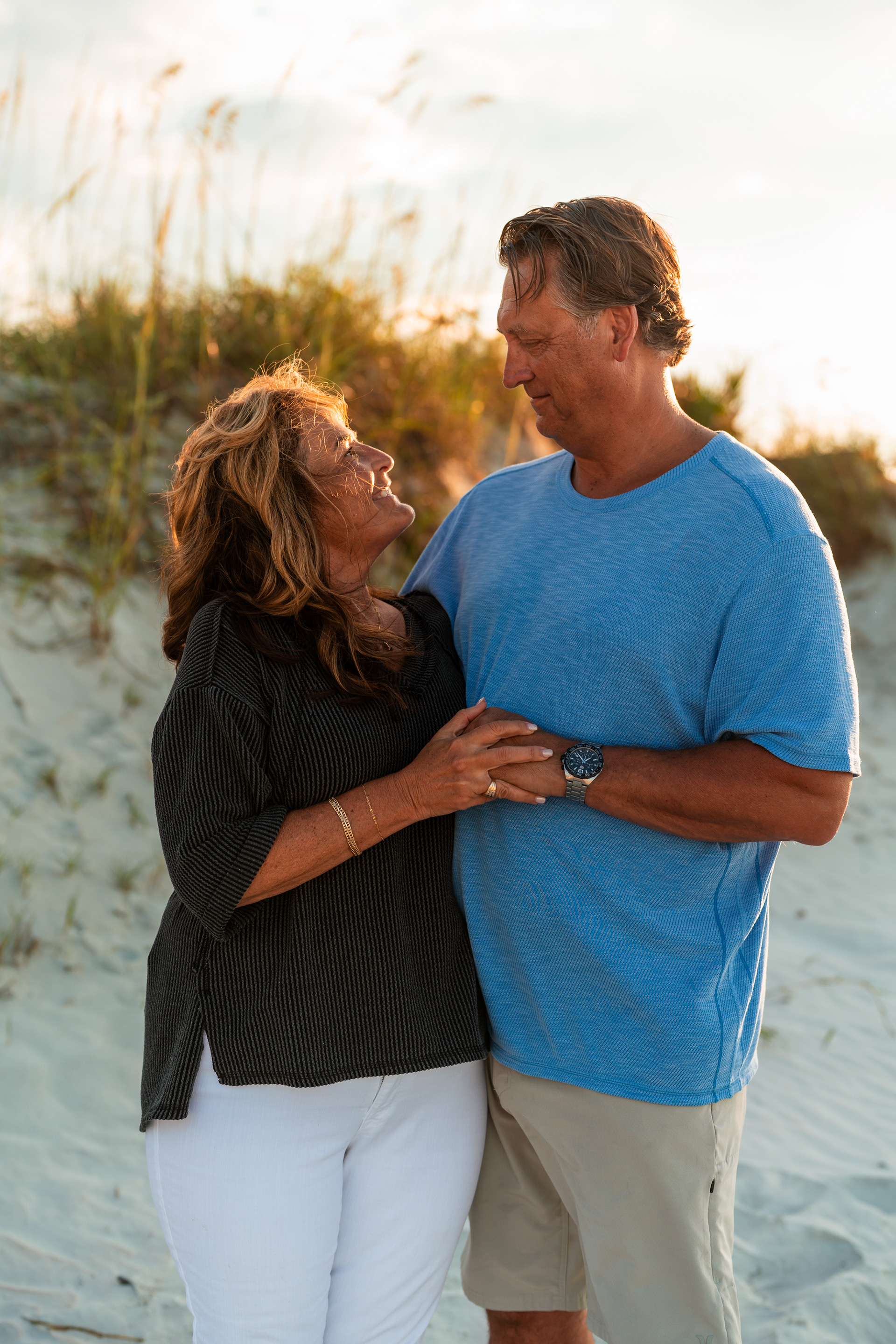 Couple standing together in the dunes during a Ponce Inlet beach photo session.