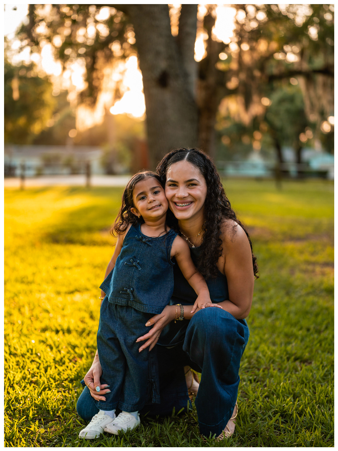 Mother and daughter smiling together during outdoor family photos in Port Orange