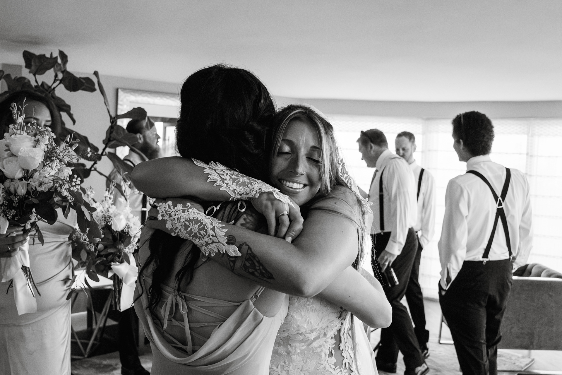 Black and white candid hug before a Hard Rock Hotel Daytona Beach wedding ceremony.