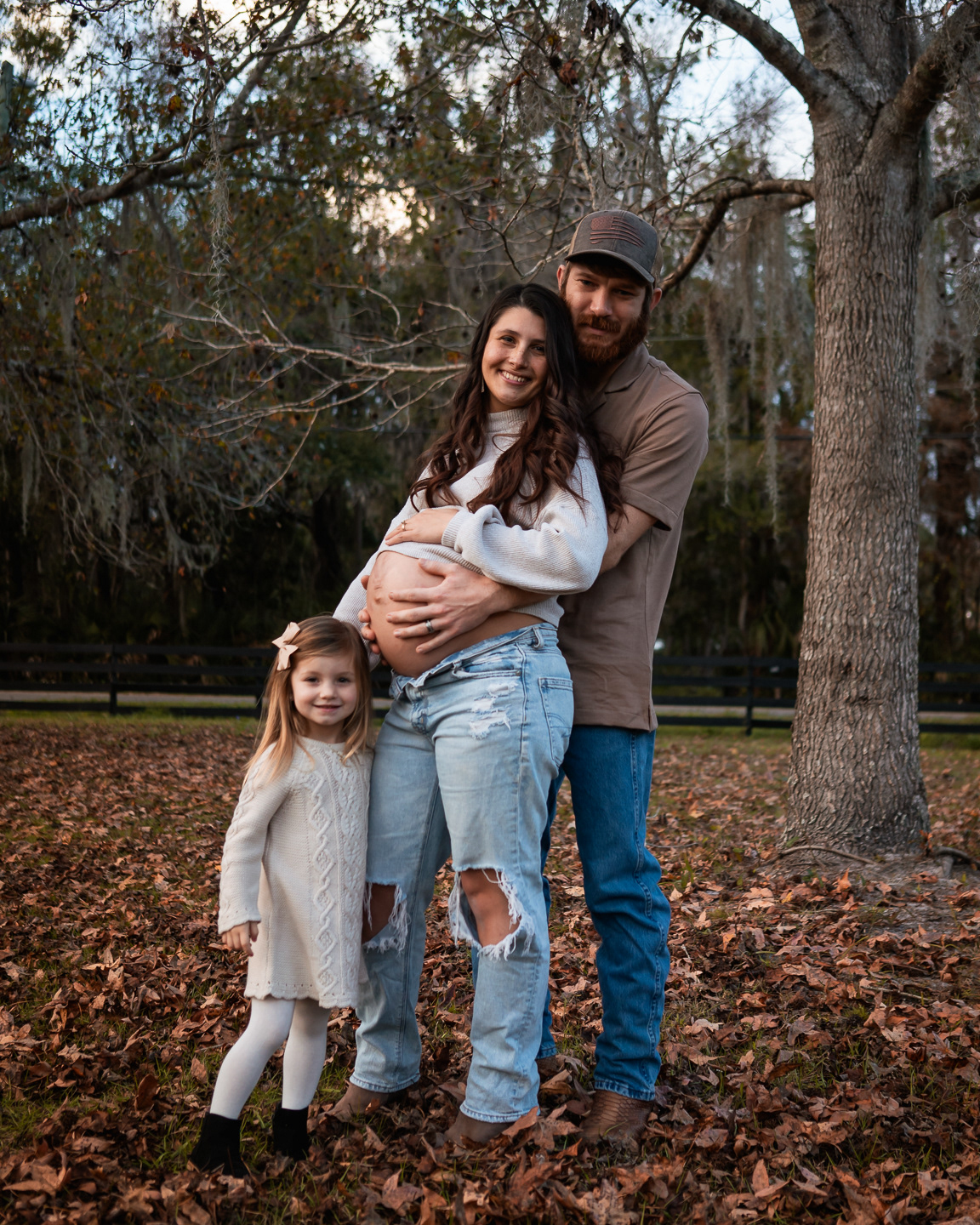Outdoor family maternity portrait with parents and child in Volusia County Florida
