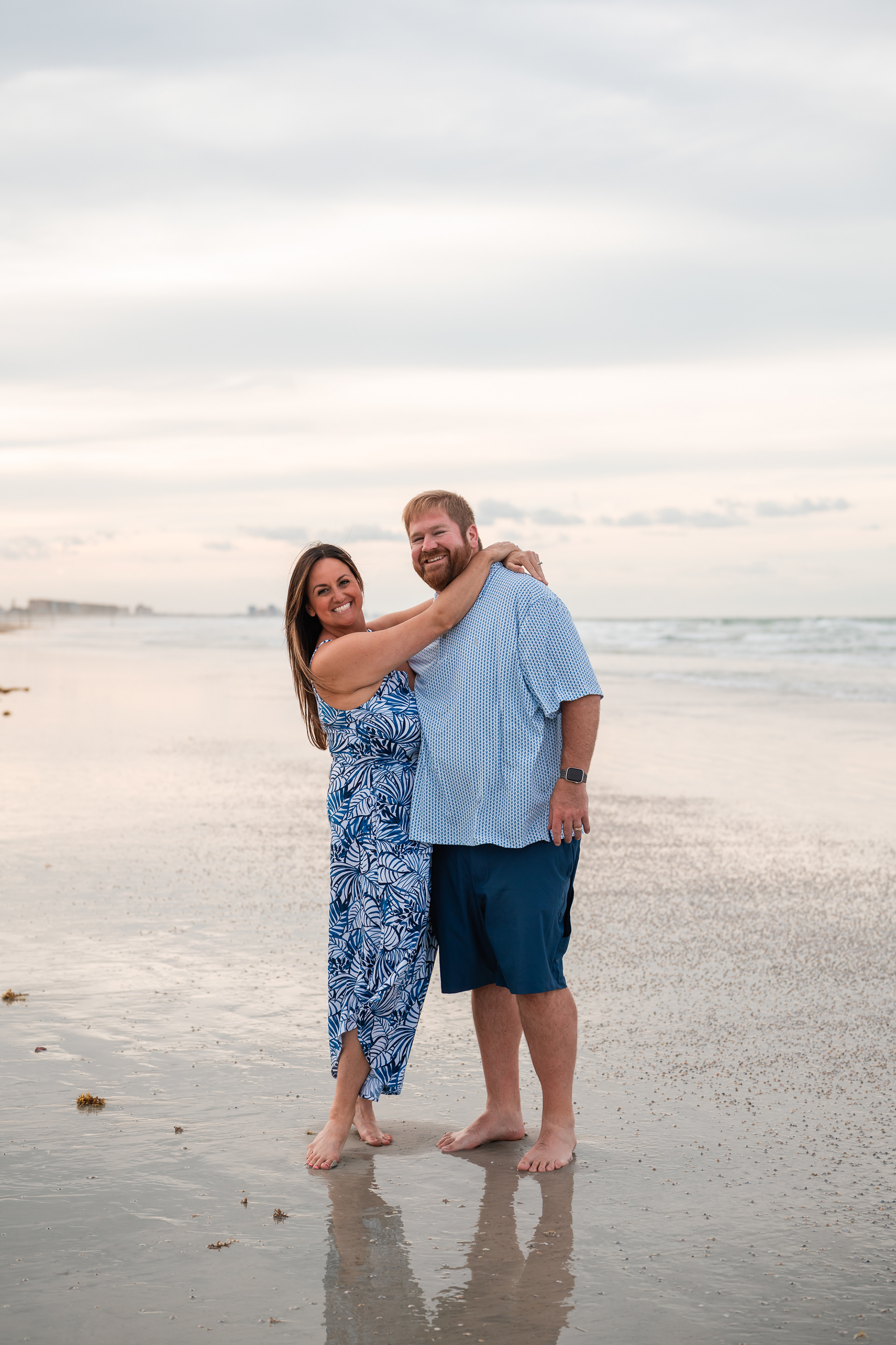 Couple standing together on the shoreline during a Ponce Inlet Beach photography session.