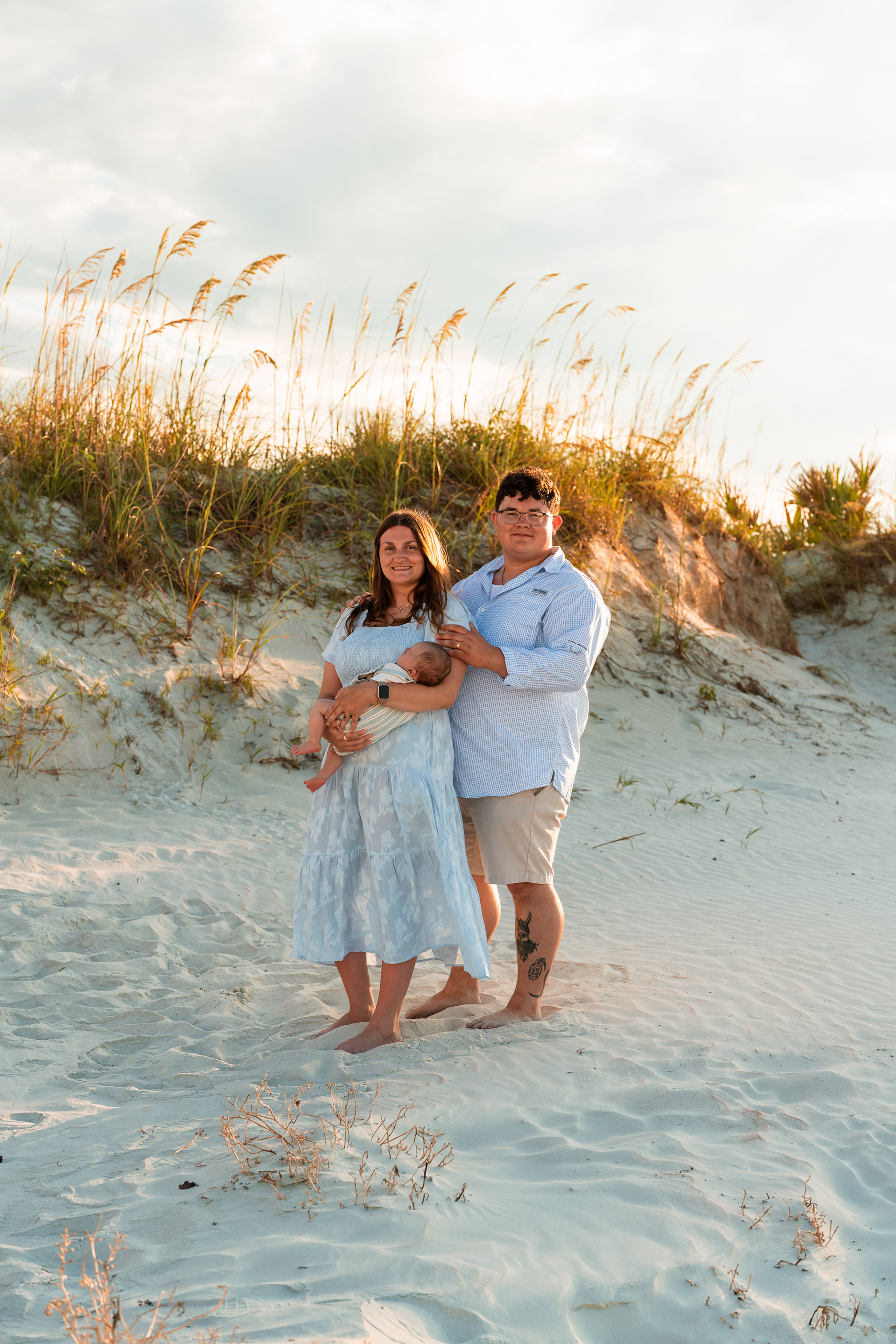 Parents walking together with their baby during a beach family photography session in Ponce Inlet.