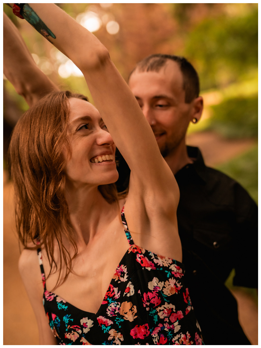 Woman smiling while being twirled by her partner during a Washington Oaks Gardens photo session.