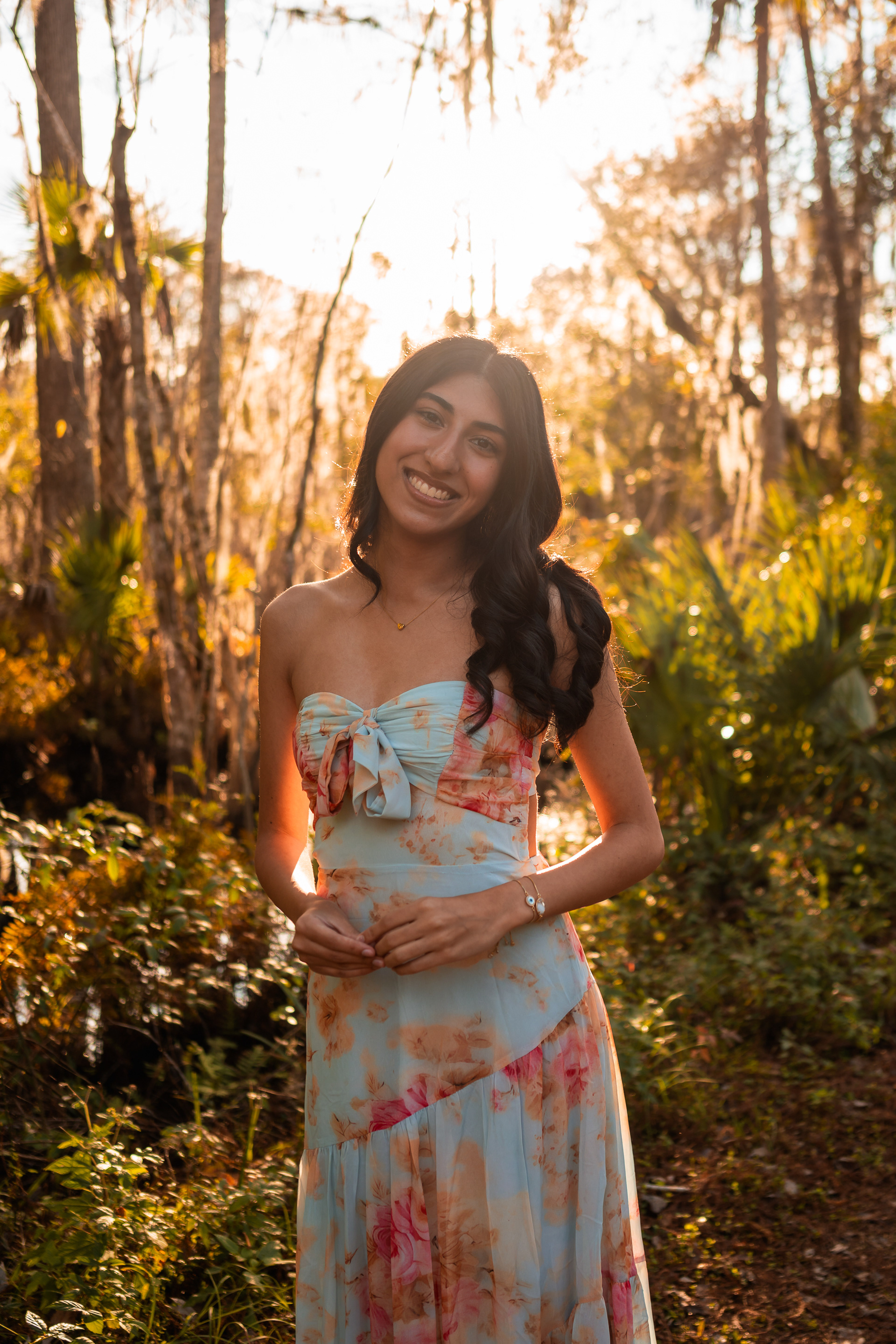 Ahaana standing in soft natural light during senior portraits in Volusia County