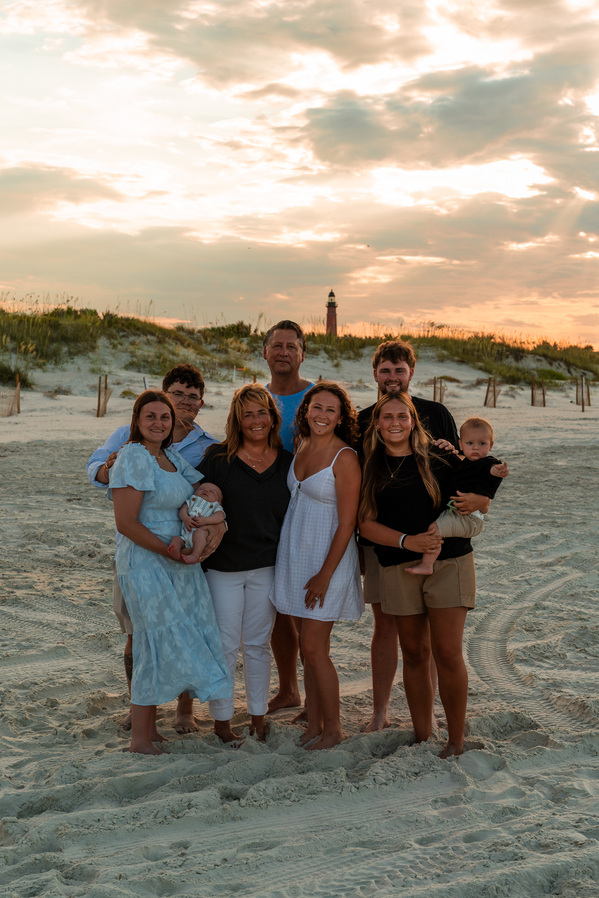 Extended family portrait on the beach with Ponce Inlet Lighthouse in the background.