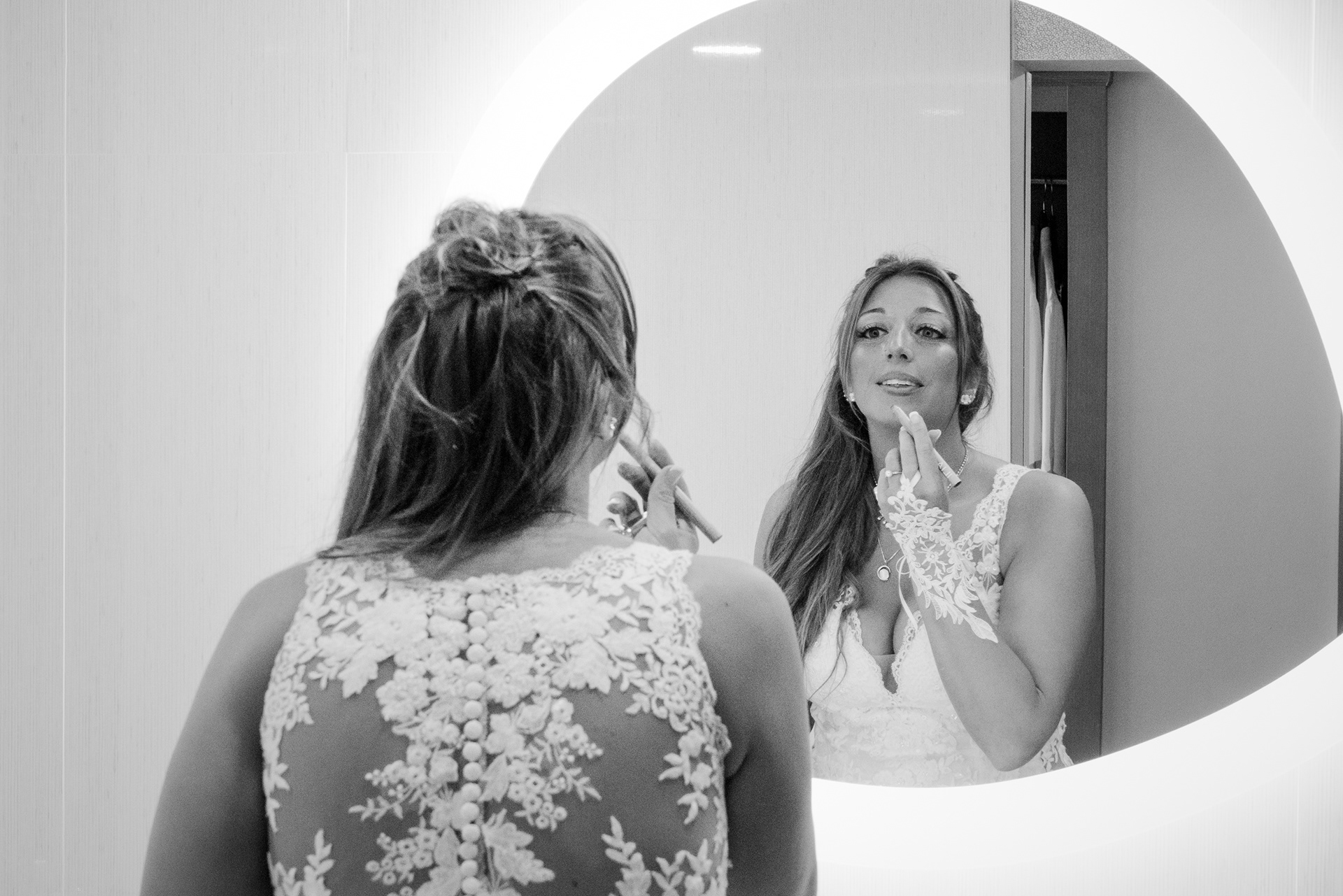 Bride getting ready in the mirror before her Hard Rock Hotel Daytona Beach wedding.