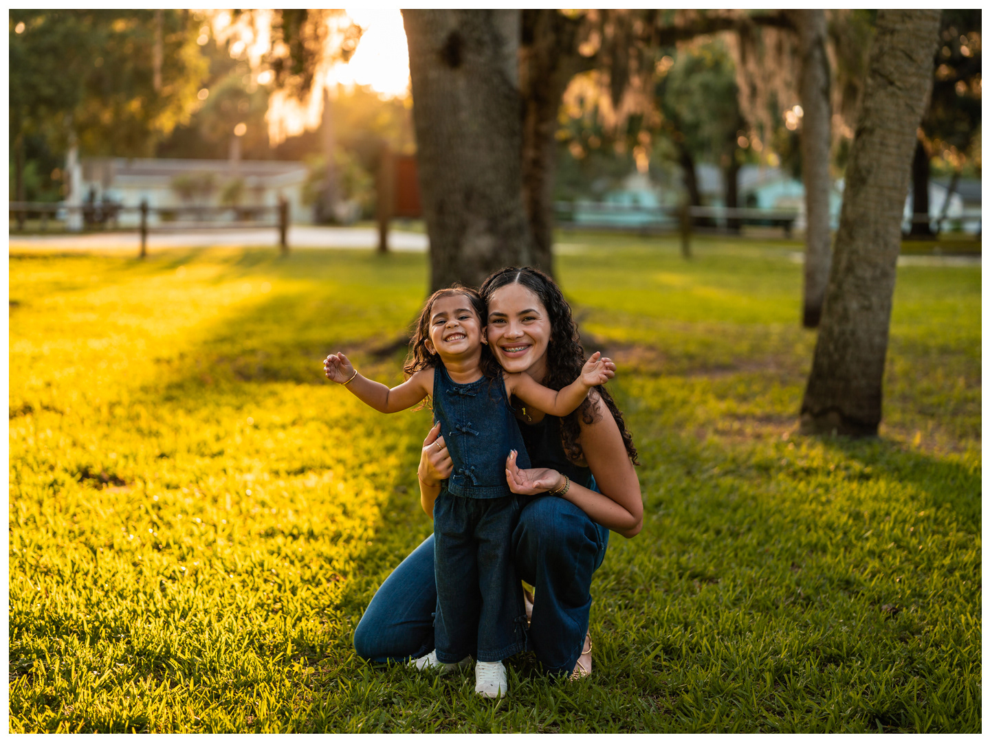 Mother and daughter sitting together under trees at Buschman Park in Port Orange