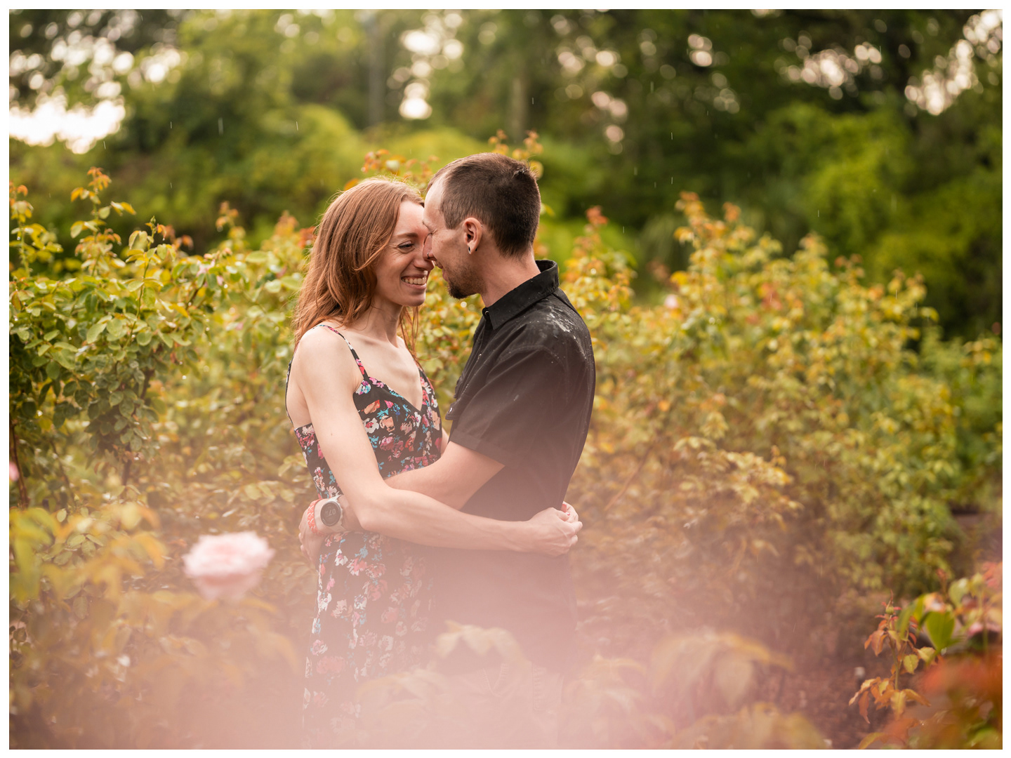 Couple embracing among the flowers during a Washington Oaks Gardens couples photography session.