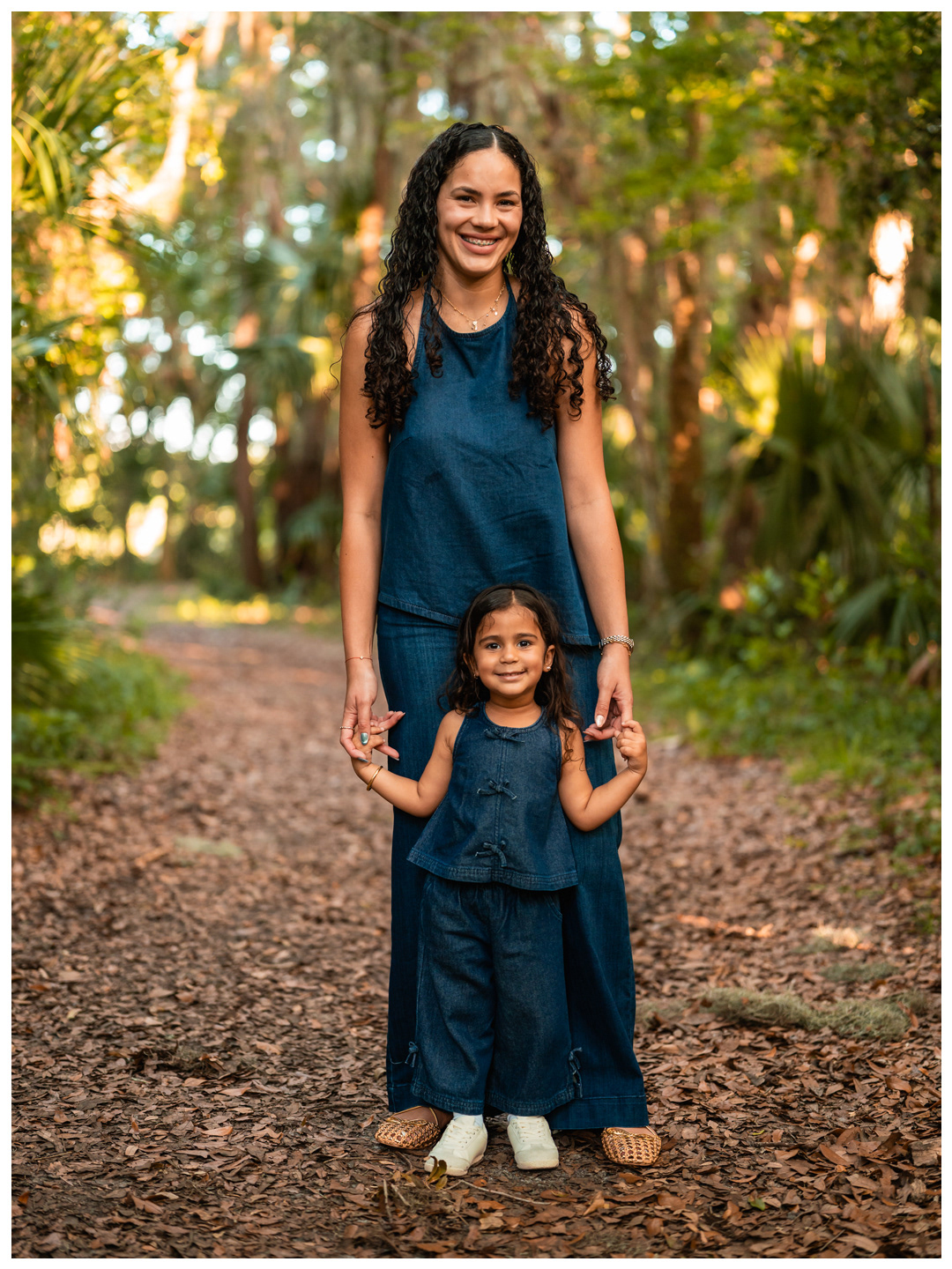 Mother standing with daughter during Port Orange family photos at Buschman Park