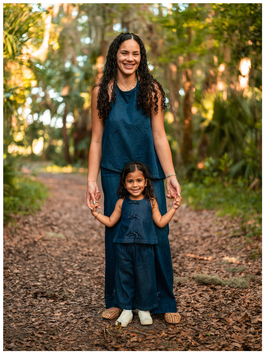 Full body mother and daughter portrait on wooded path at Buschman Park