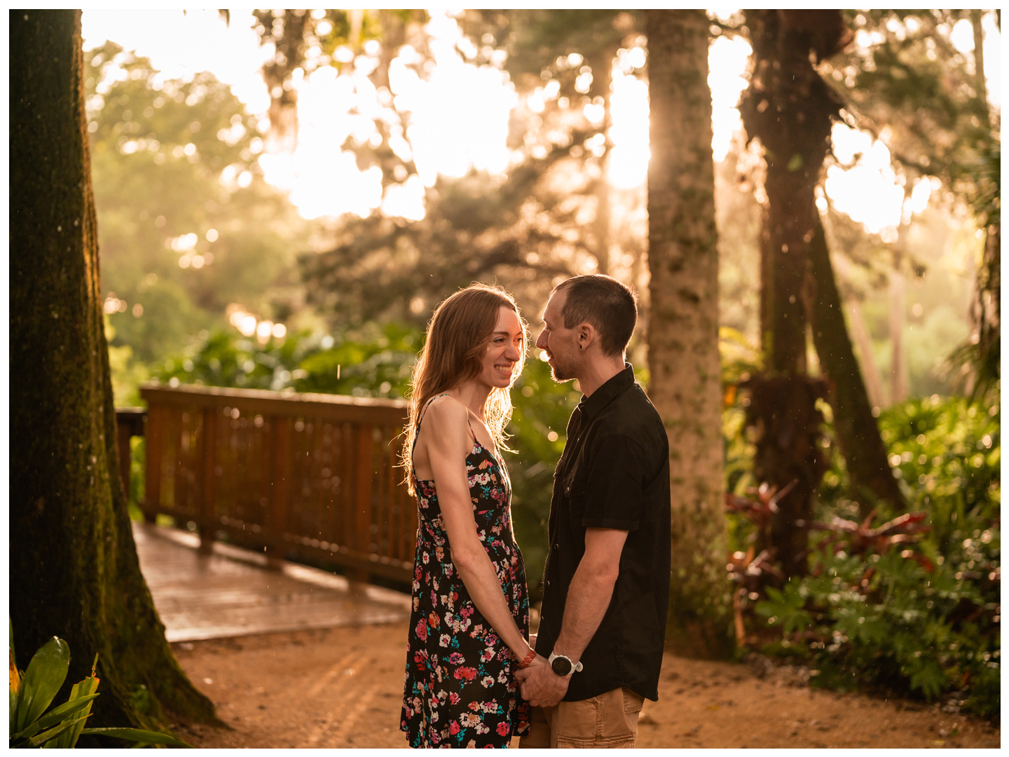 Couple holding hands on a garden path in warm evening light at Washington Oaks Gardens State Park.