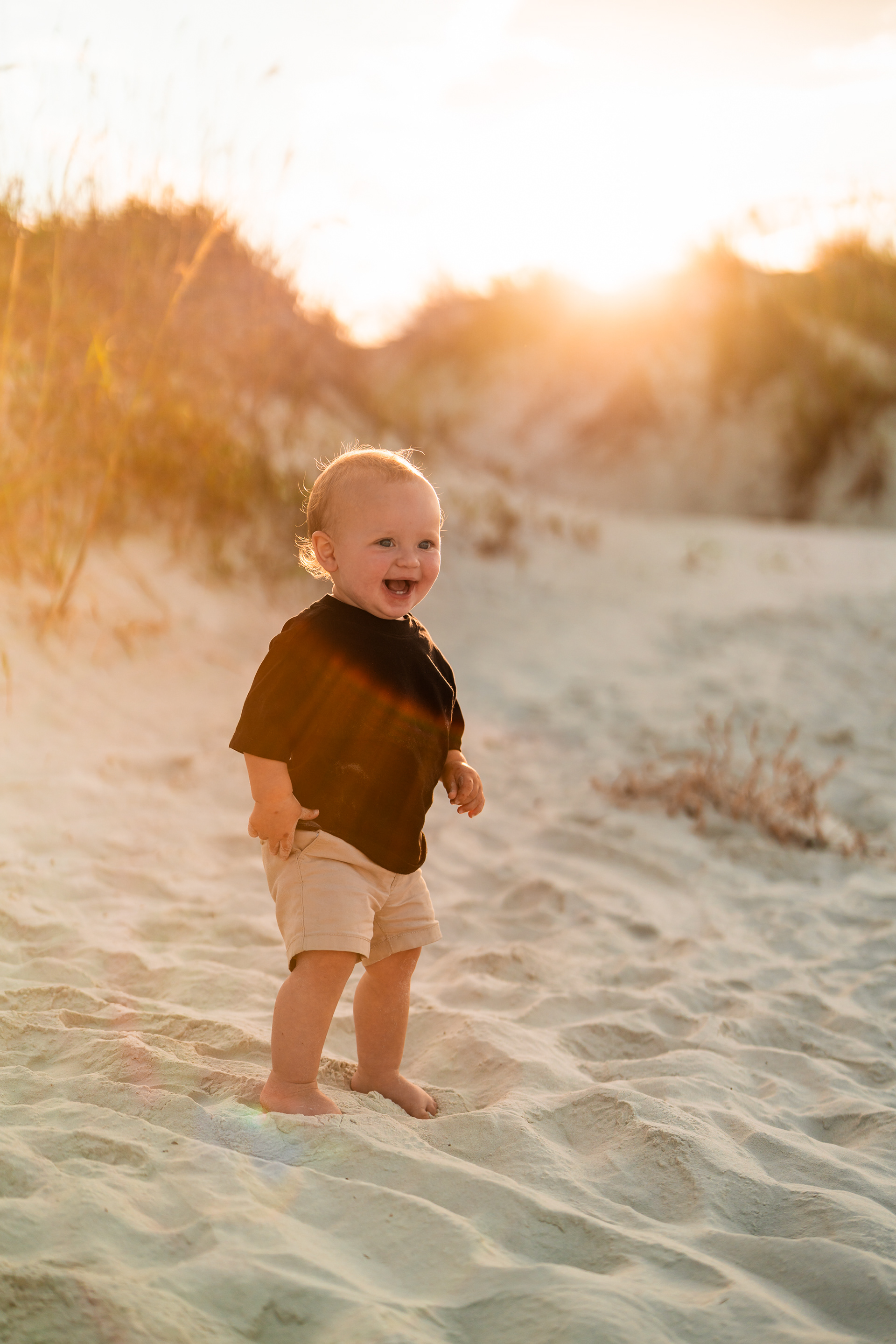 Toddler standing in the sand during a family photo session at Ponce Inlet Jetty Beach.