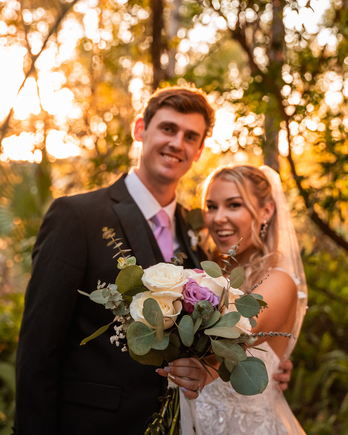 Bride and groom portrait with bouquet during golden hour at Bridle Oaks Barn wedding in DeLand Florida