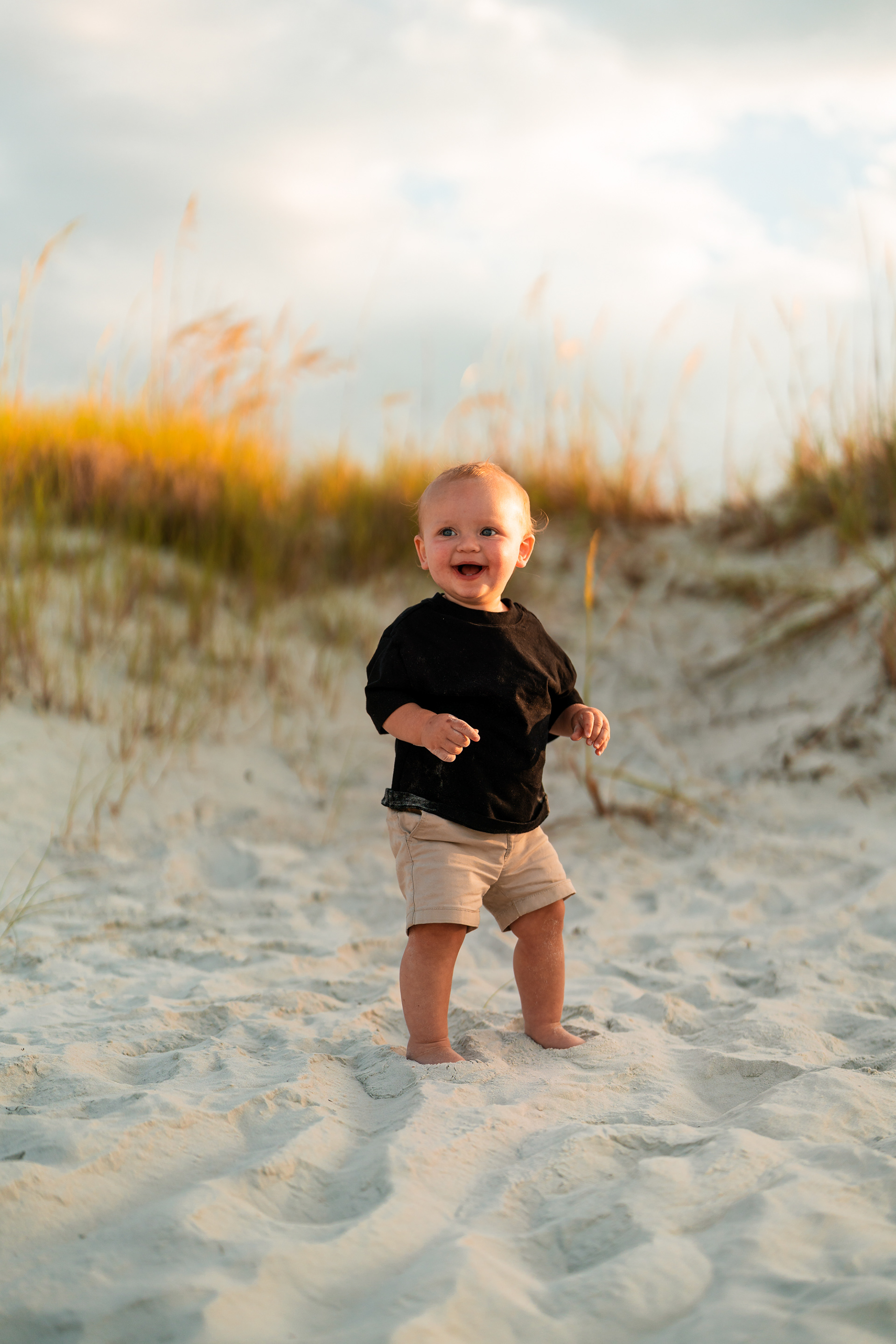 Toddler standing in the sand during a beach family photography session in Ponce Inlet.