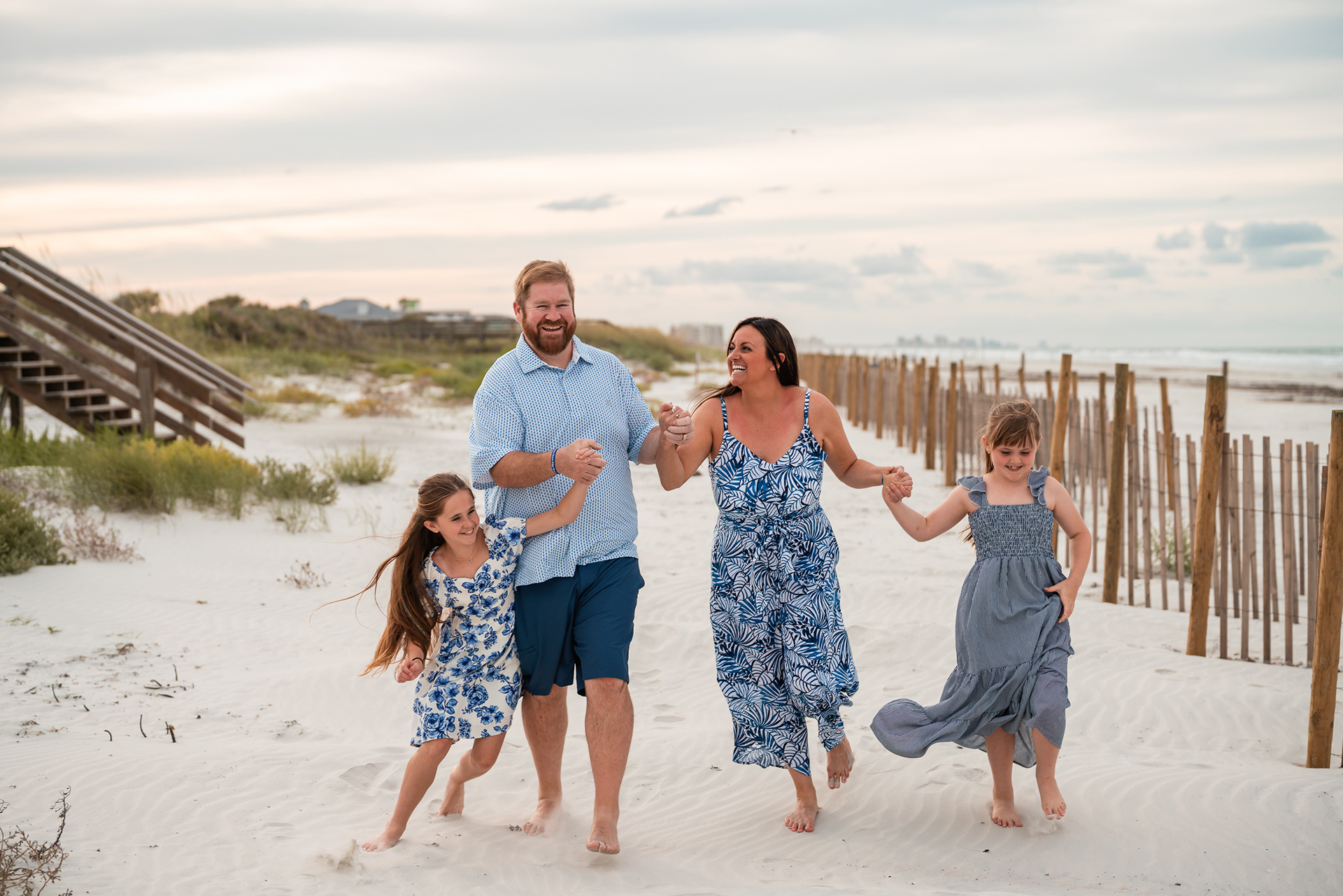 Family walking through the sand during a Ponce Inlet Beach family photo session.
