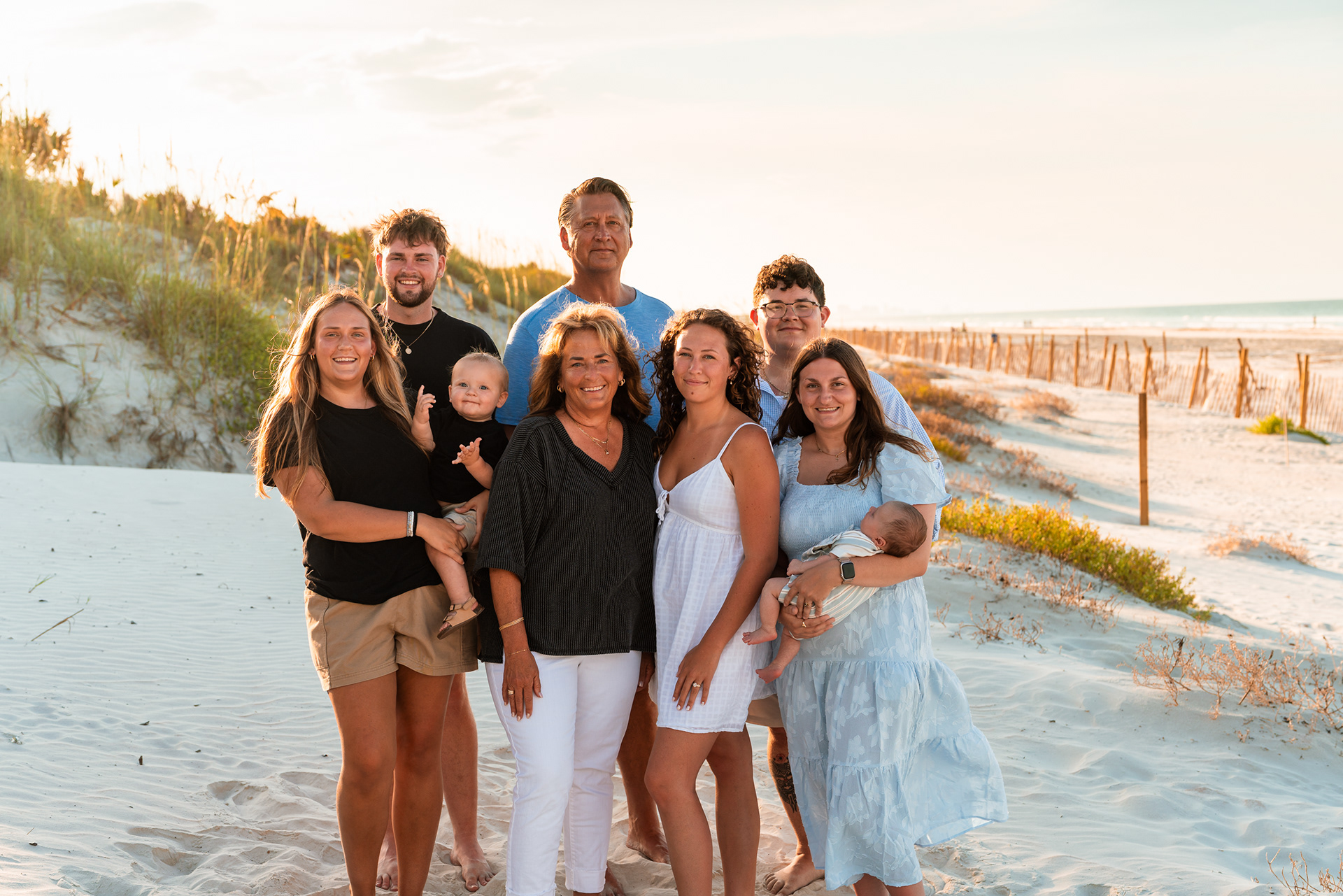 Extended family standing together on the beach during a Ponce Inlet family photography session.